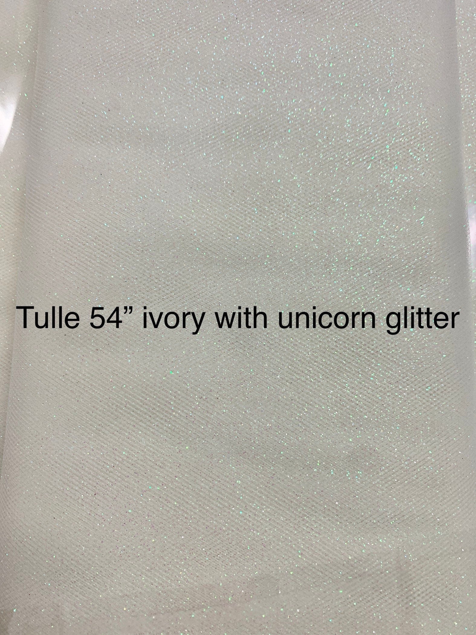 Ivory Tulle Gliter 54" double fold, color Ivory with unicorn glitter 10 yards per pack.