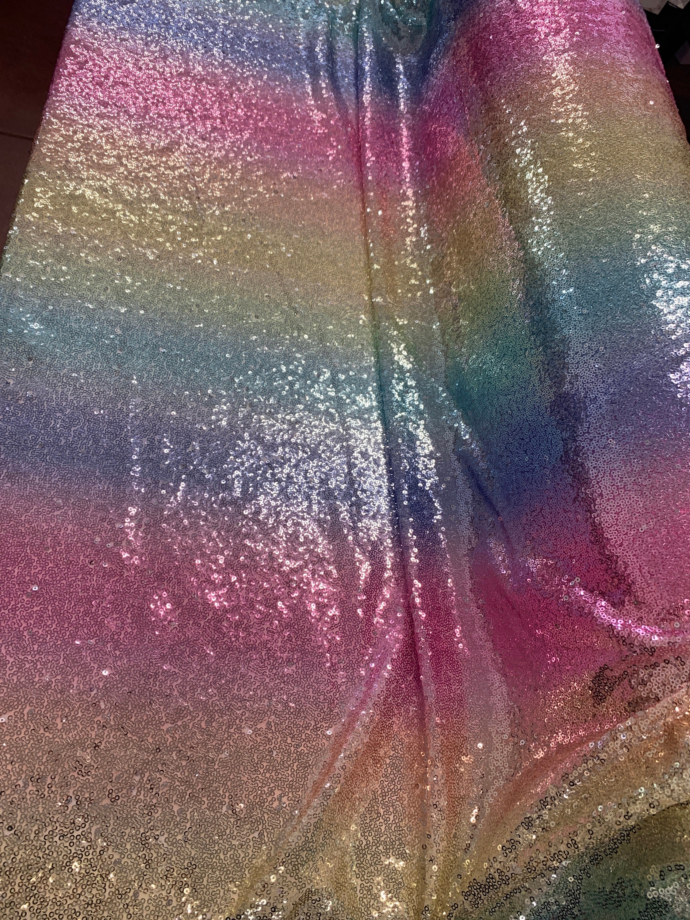 Rainbow sequins mesh fabric. common use in craft, jacket, costume, dull, table runner. 2 to 3 inches plain mesh on each side.