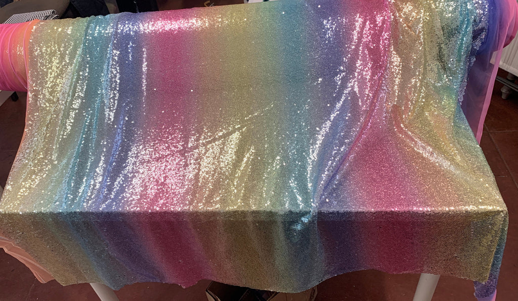 Rainbow sequins mesh fabric. common use in craft, jacket, costume, dull, table runner. 2 to 3 inches plain mesh on each side.