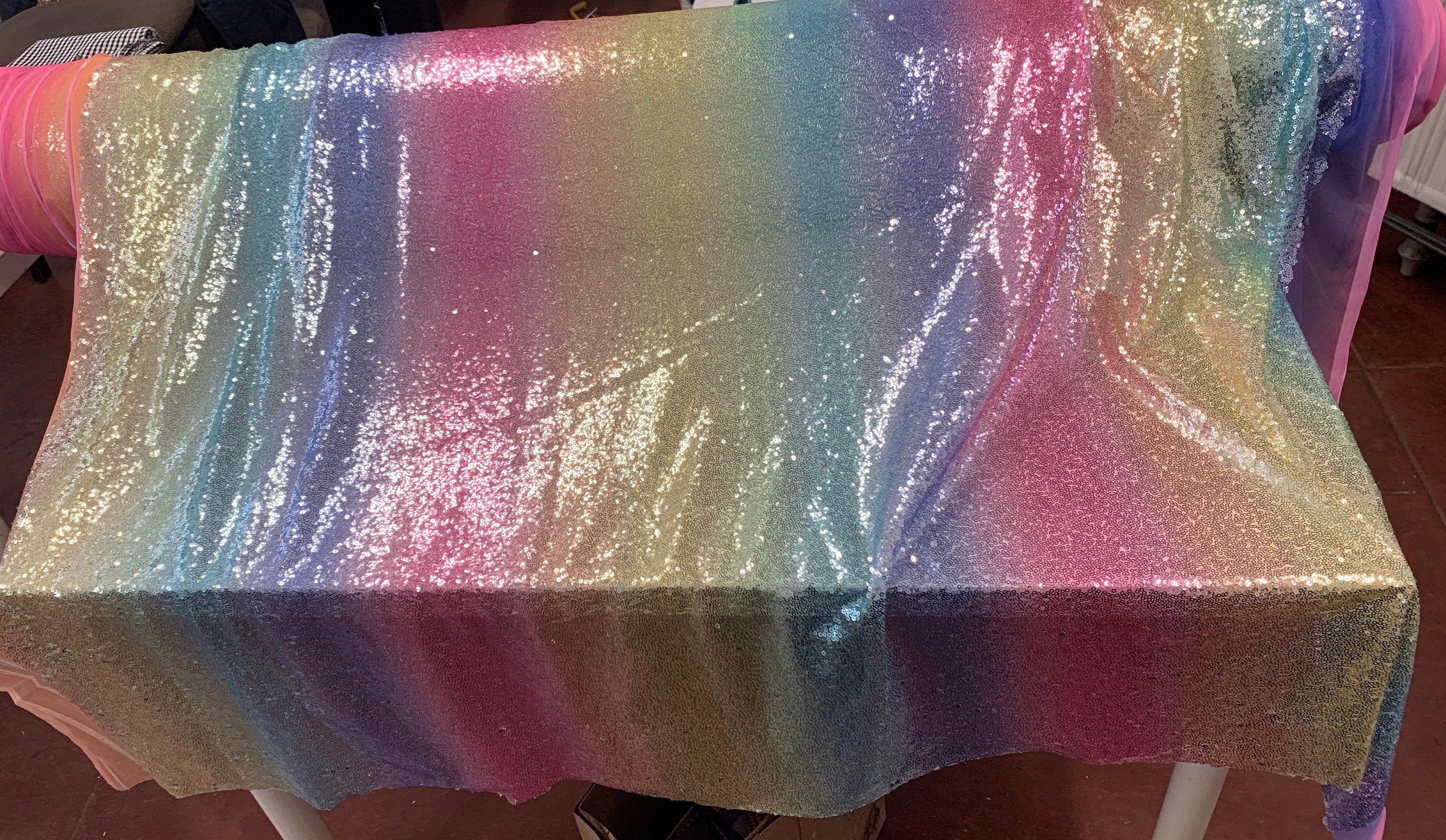 Rainbow sequins mesh fabric. common use in craft, jacket, costume, dull, table runner. 2 to 3 inches plain mesh on each side.
