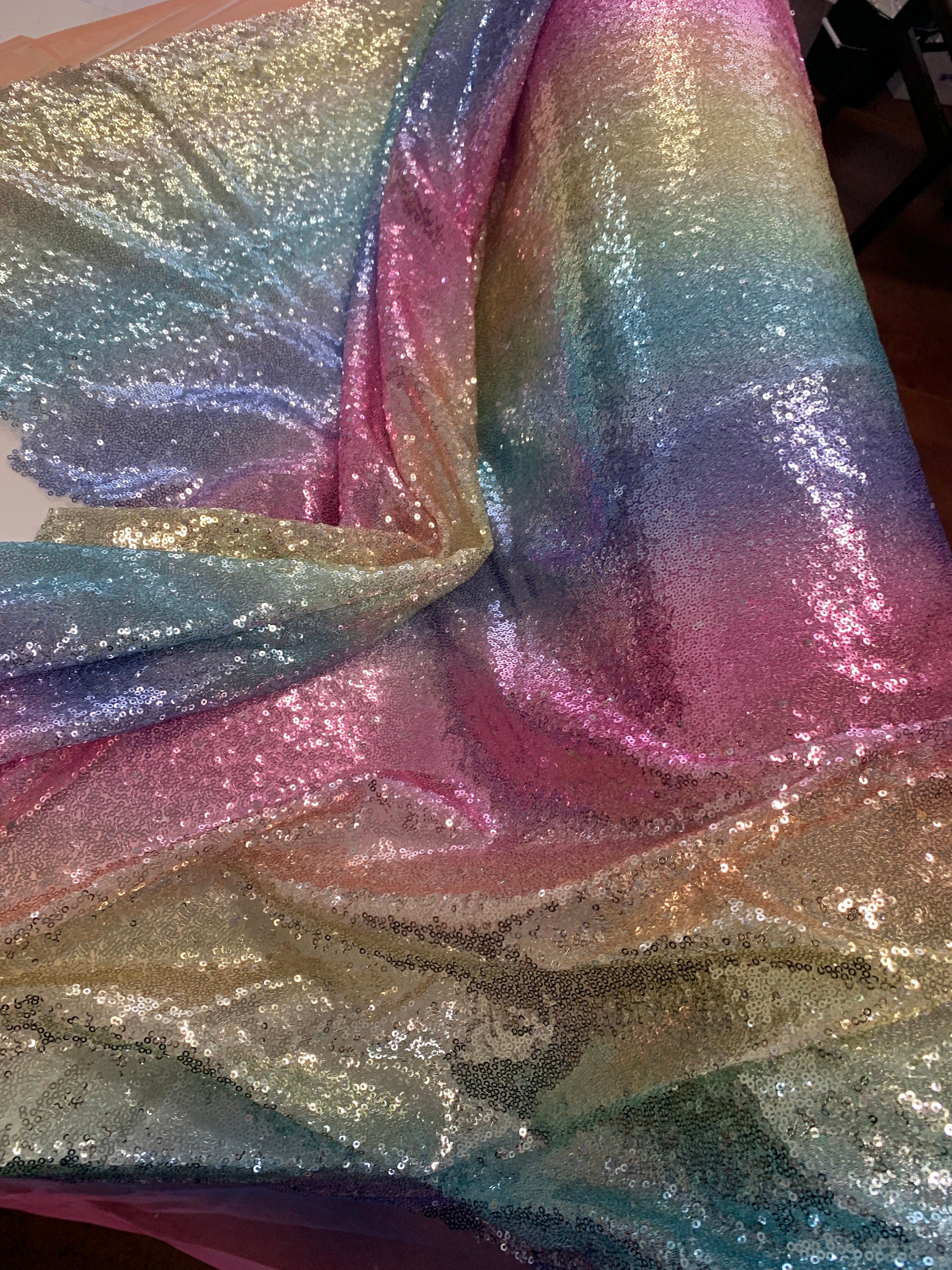 Rainbow sequins mesh fabric. common use in craft, jacket, costume, dull, table runner. 2 to 3 inches plain mesh on each side.