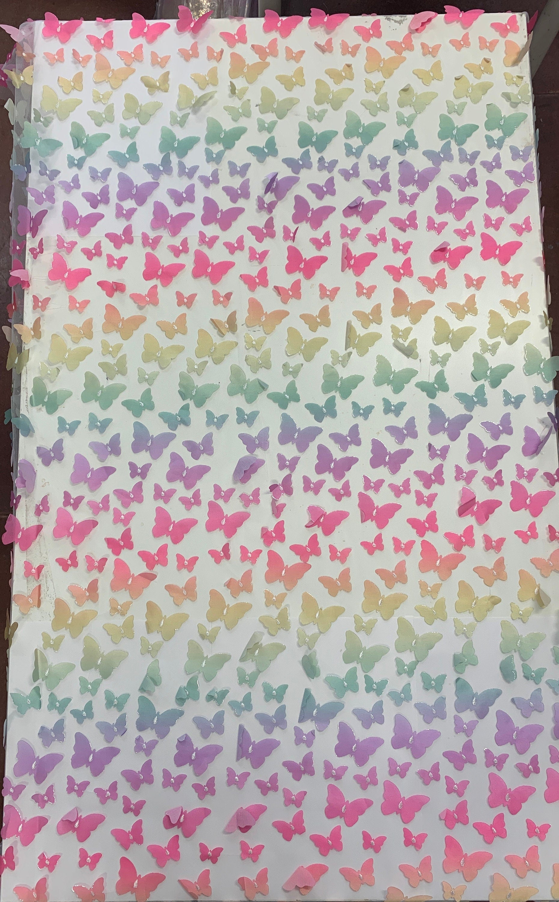 lace Butterfly on mesh design fabric. color rainbow. 60 inch width,fabric has 5 inch plain salvage on each side. butterfly are is 50 inches.