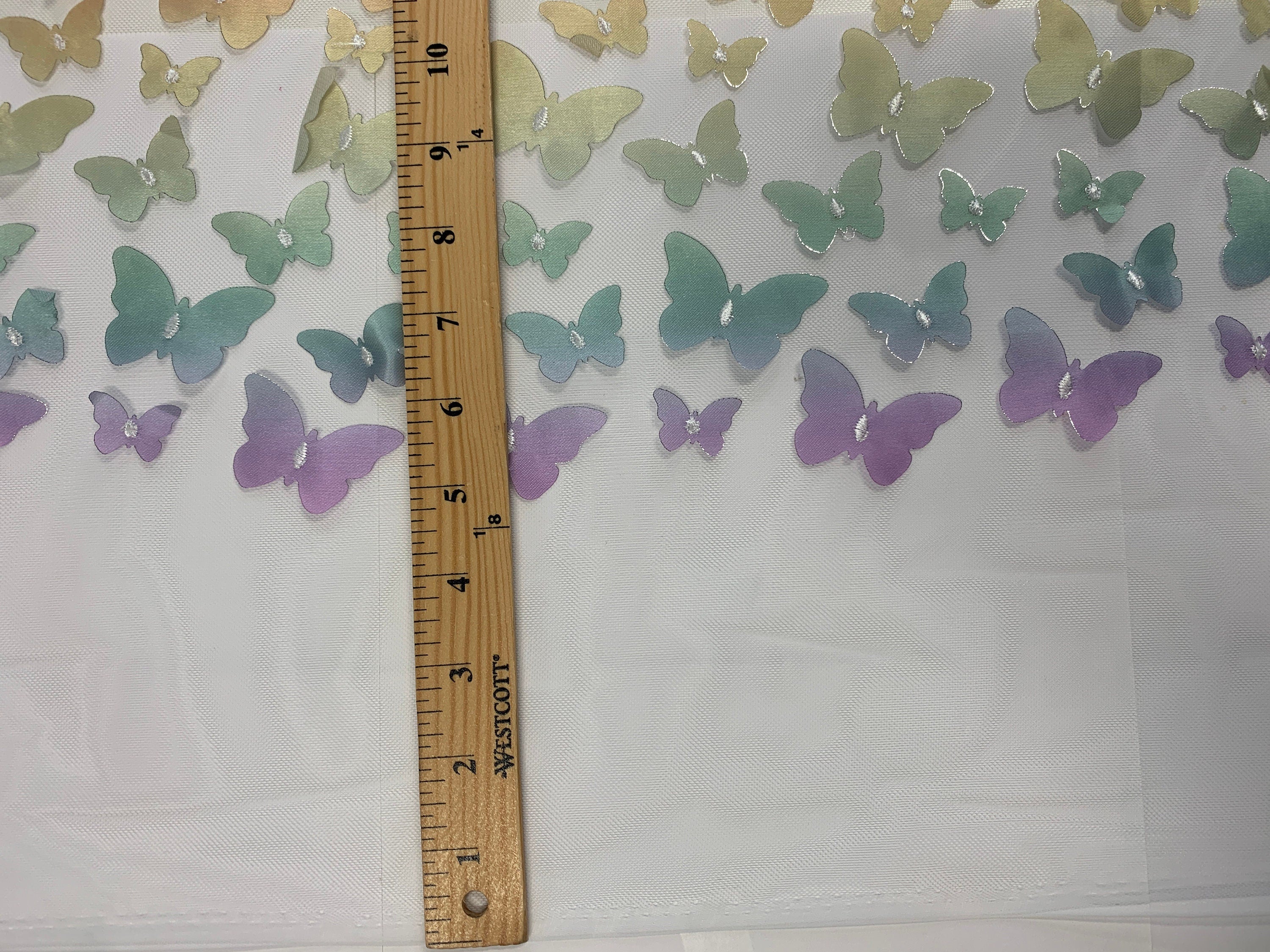 lace Butterfly on mesh design fabric. color rainbow. 60 inch width,fabric has 5 inch plain salvage on each side. butterfly are is 50 inches.