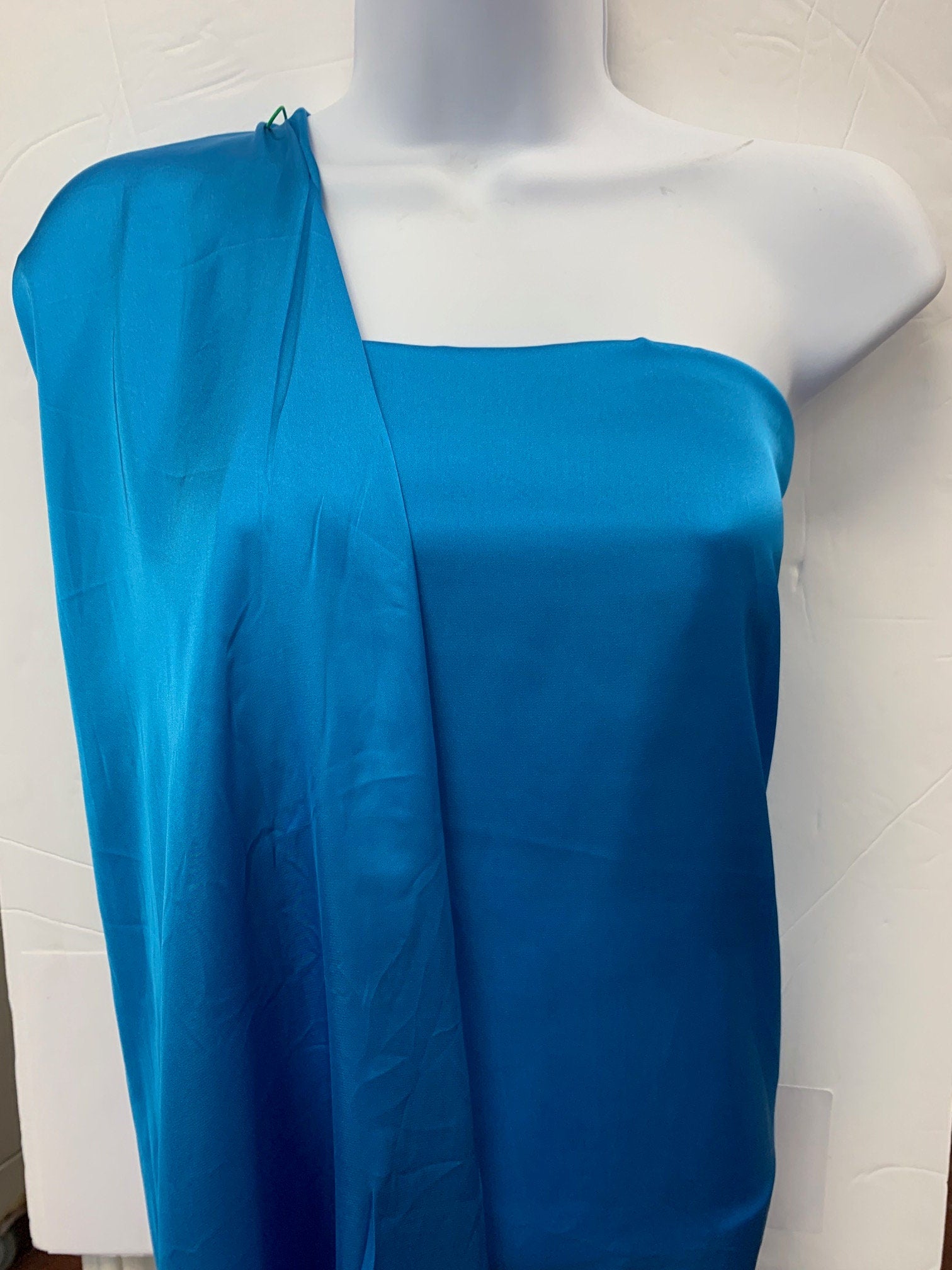 Silky dull satin fabric sell by yard 58/60" 100% polyester. Turquoise colorsmooth texture. Perfect for stylish tops and blouses.