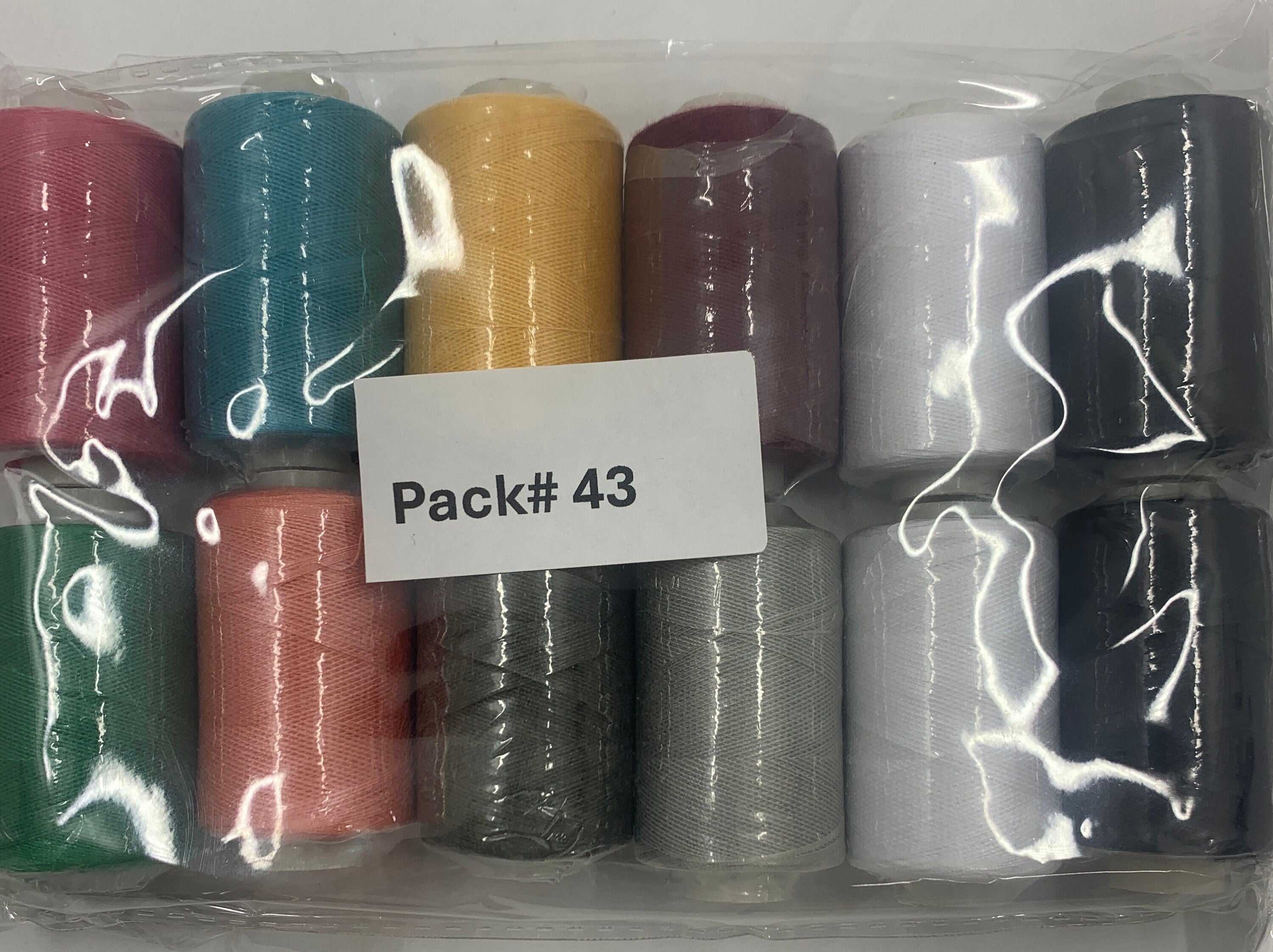 Sewing threads 12 assorted colors per package, each package assortment is different from each other, all packages has 2 black and 2 white.