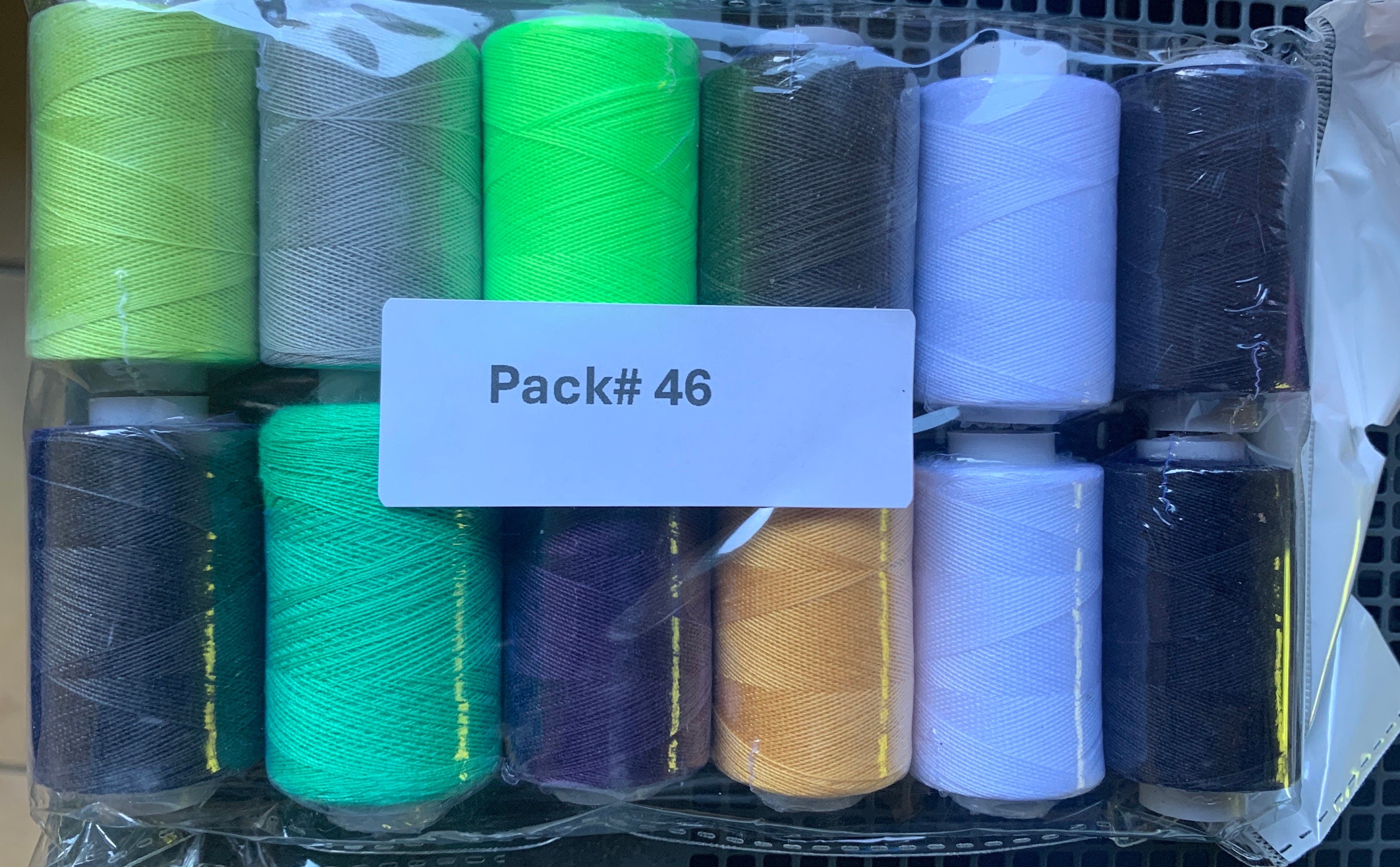 Sewing threads 12 assorted colors per package, each package assortment is different from each other, all packages has 2 black and 2 white.