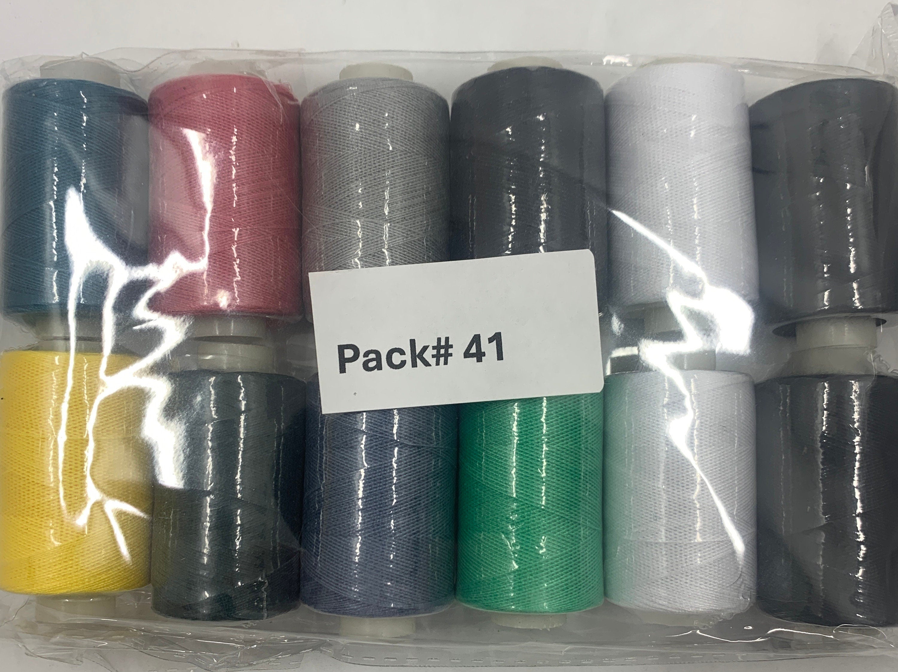 Sewing threads 12 assorted colors per package, each package assortment is different from each other, all packages has 2 black and 2 white.