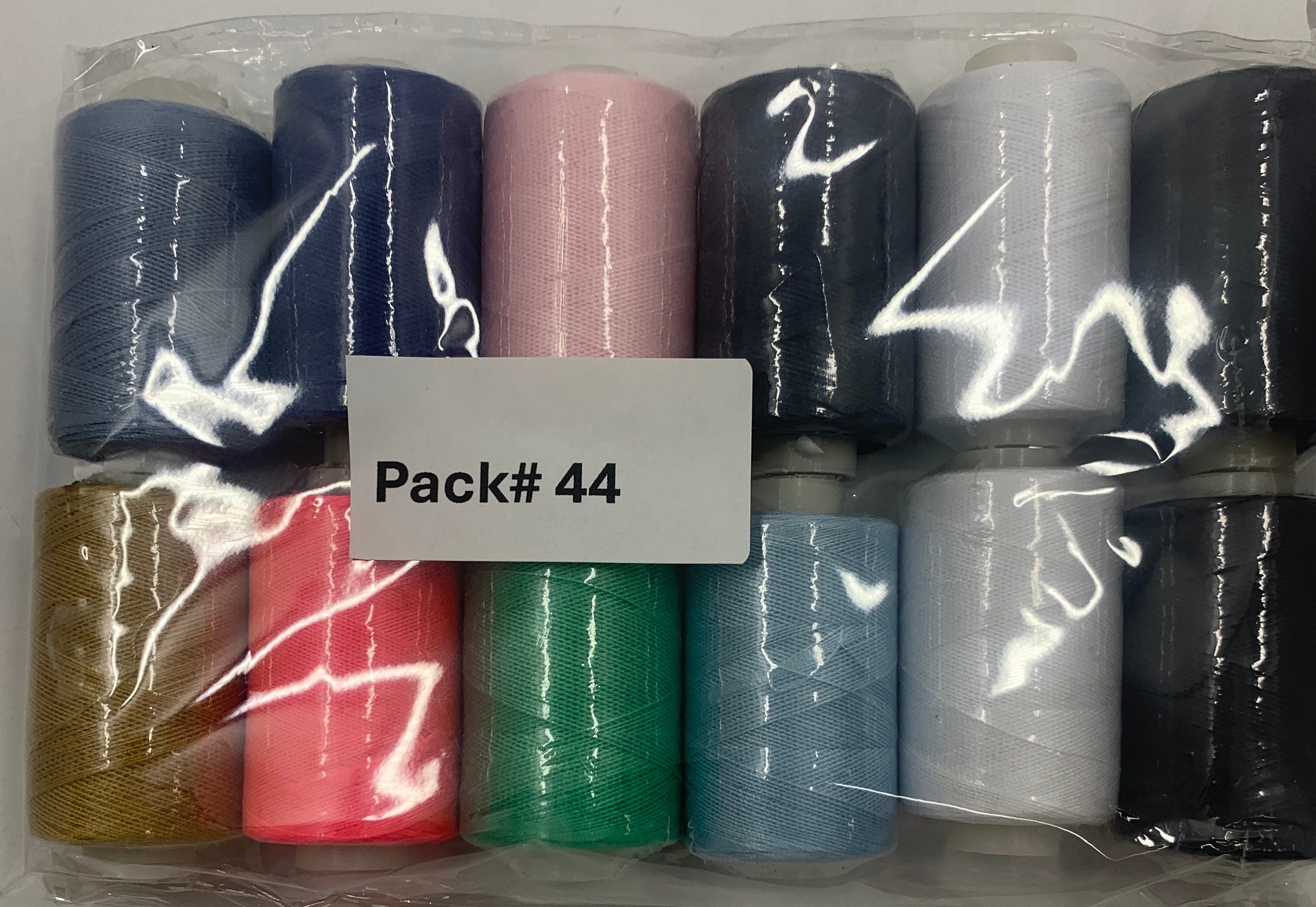 Sewing threads 12 assorted colors per package, each package assortment is different from each other, all packages has 2 black and 2 white.