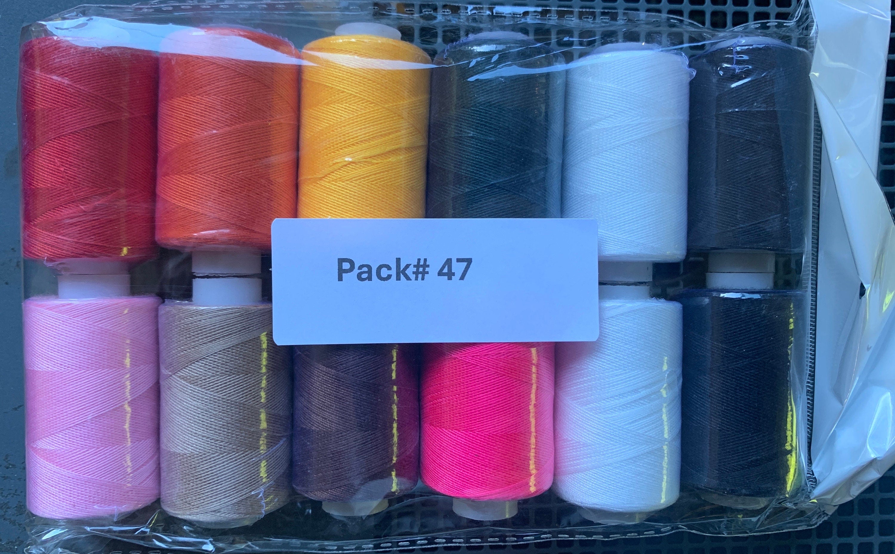 Sewing threads 12 assorted colors per package, each package assortment is different from each other, all packages has 2 black and 2 white.