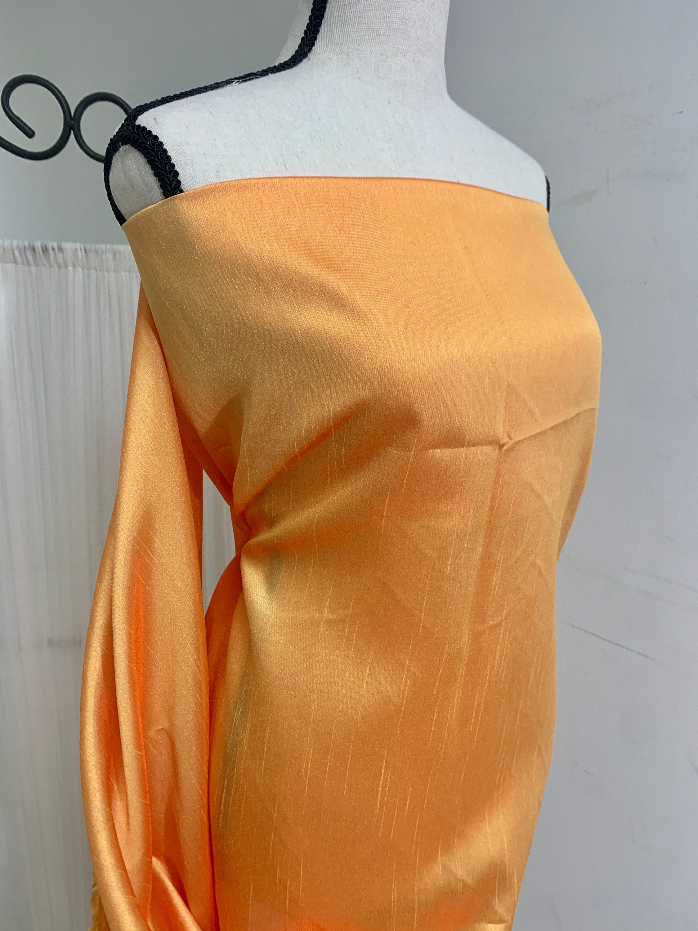 Gold Shimmer fabric two tone threads in yellow and orange, creating an orange sheen. Requires dry cleaning for maintenance. Free sample.