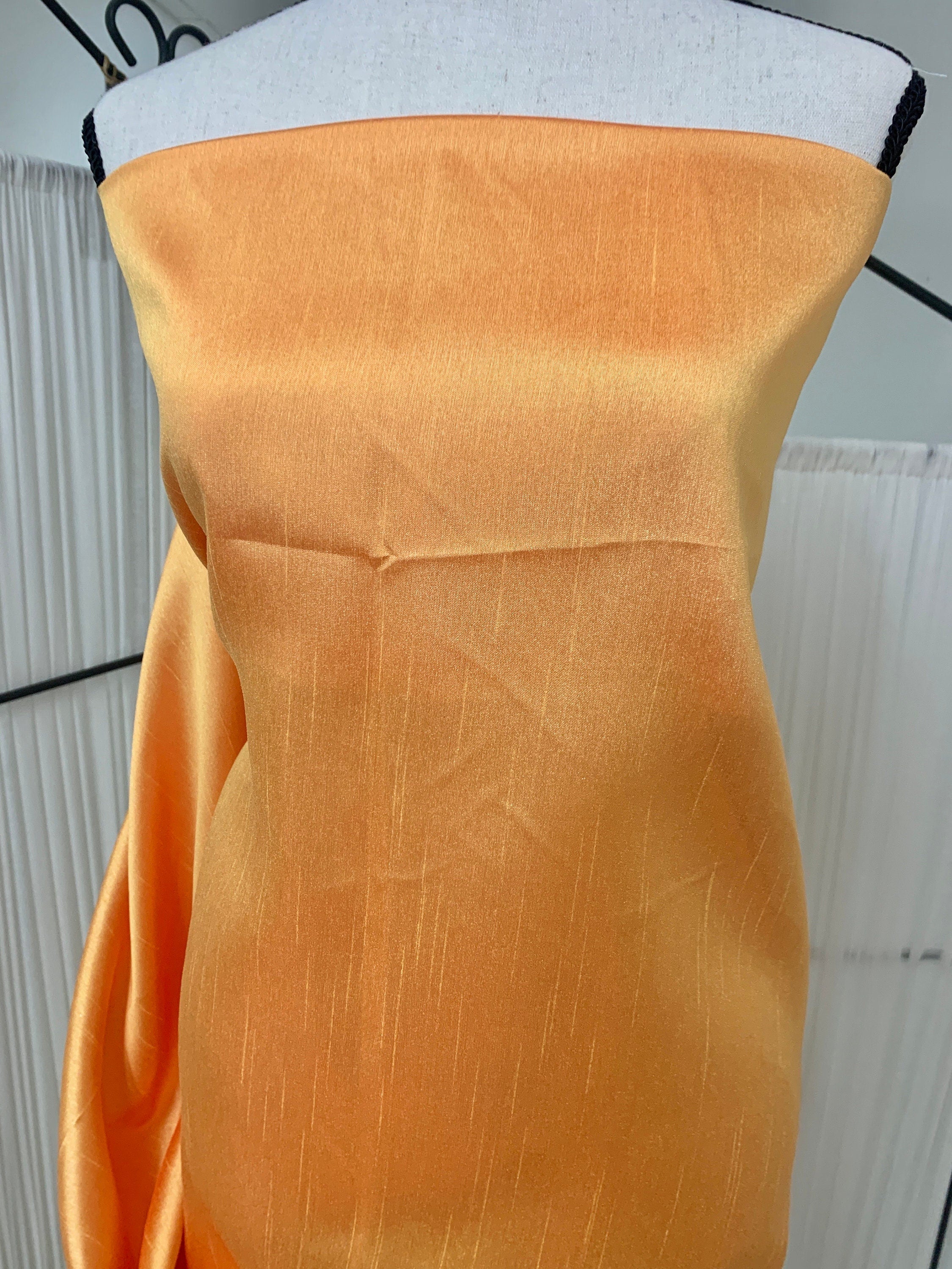 Gold Shimmer fabric two tone threads in yellow and orange, creating an orange sheen. Requires dry cleaning for maintenance. Free sample.