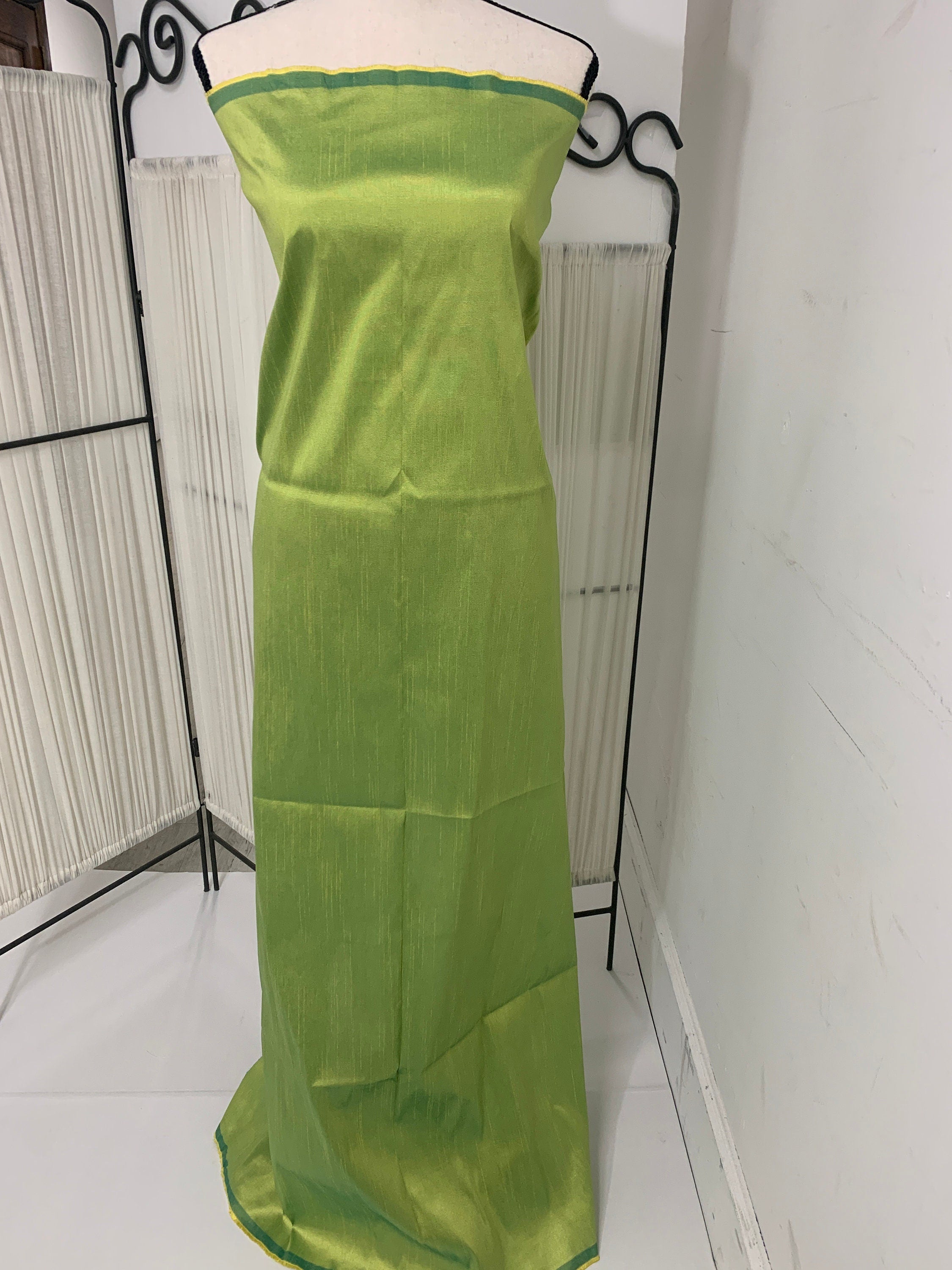 Olive poly dupioni fabric width 58". fabric has fuchsia tone, made of two different color of olive and turquoise blue. free smple.