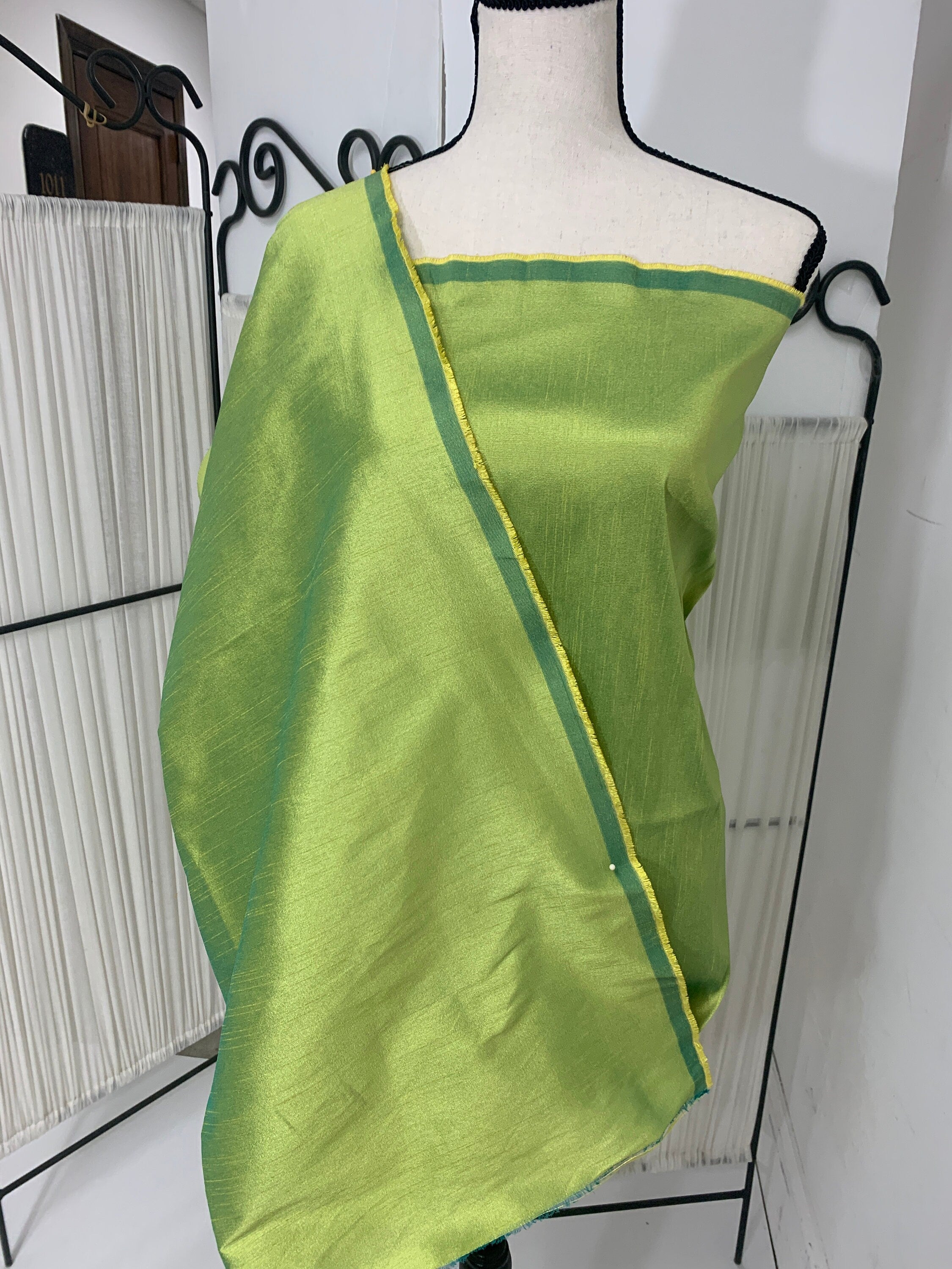 Olive poly dupioni fabric width 58". fabric has fuchsia tone, made of two different color of olive and turquoise blue. free smple.