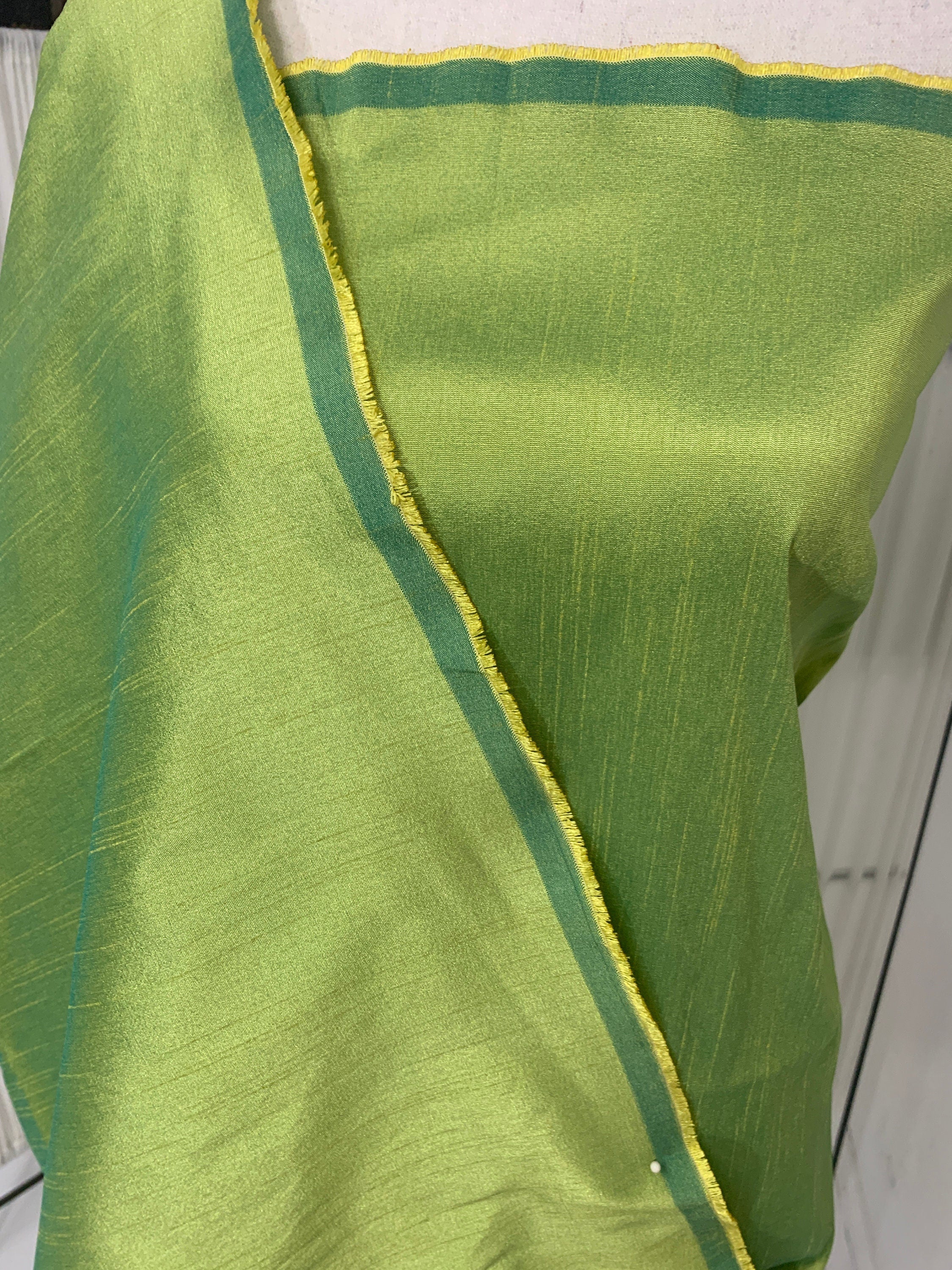 Olive poly dupioni fabric width 58". fabric has fuchsia tone, made of two different color of olive and turquoise blue. free smple.