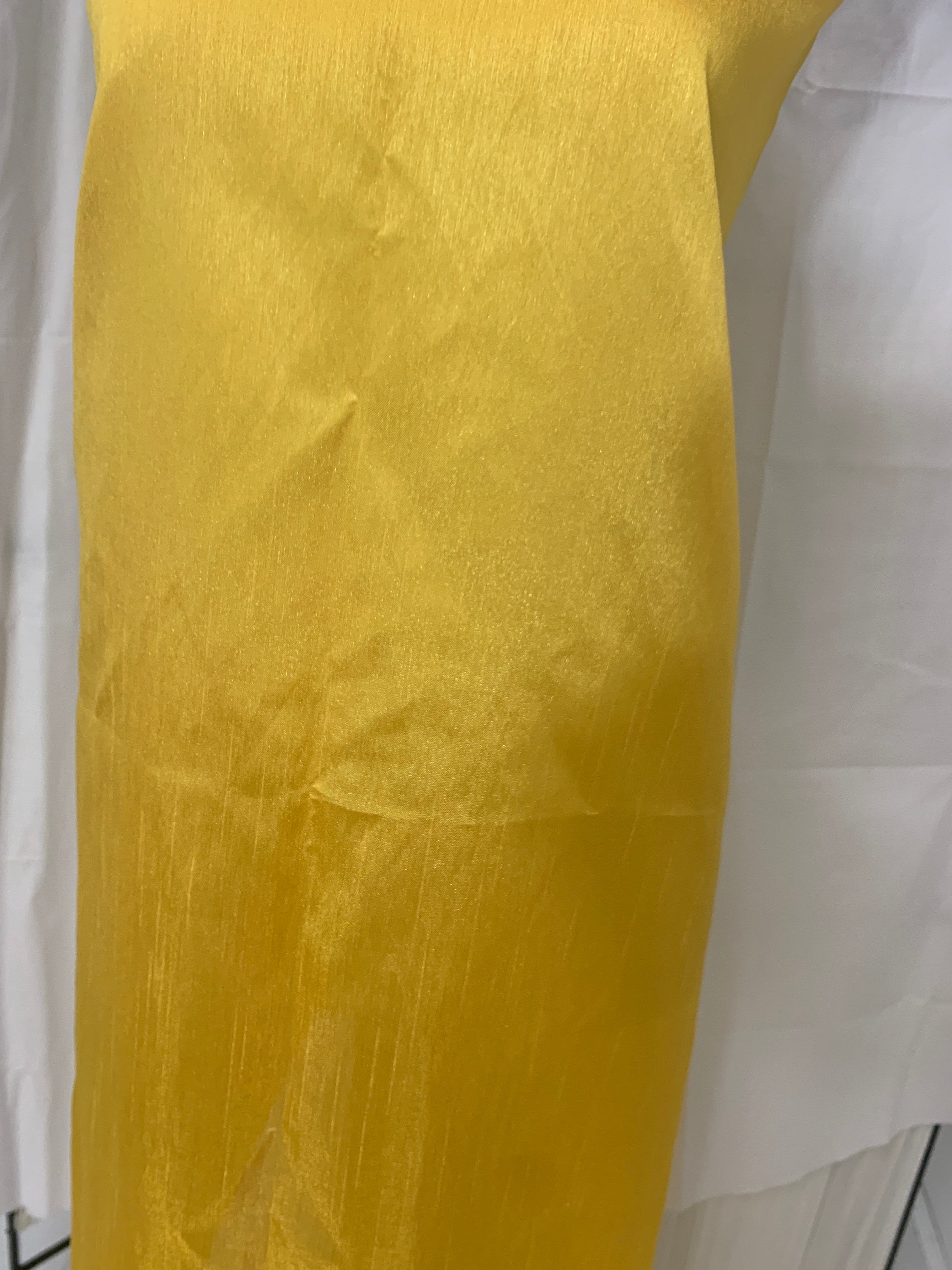 Yellow shimmer shantung fabric, width 58". Is a double sided fabric with slub, shimmery and dull sides dry clean fabric. Free sample.