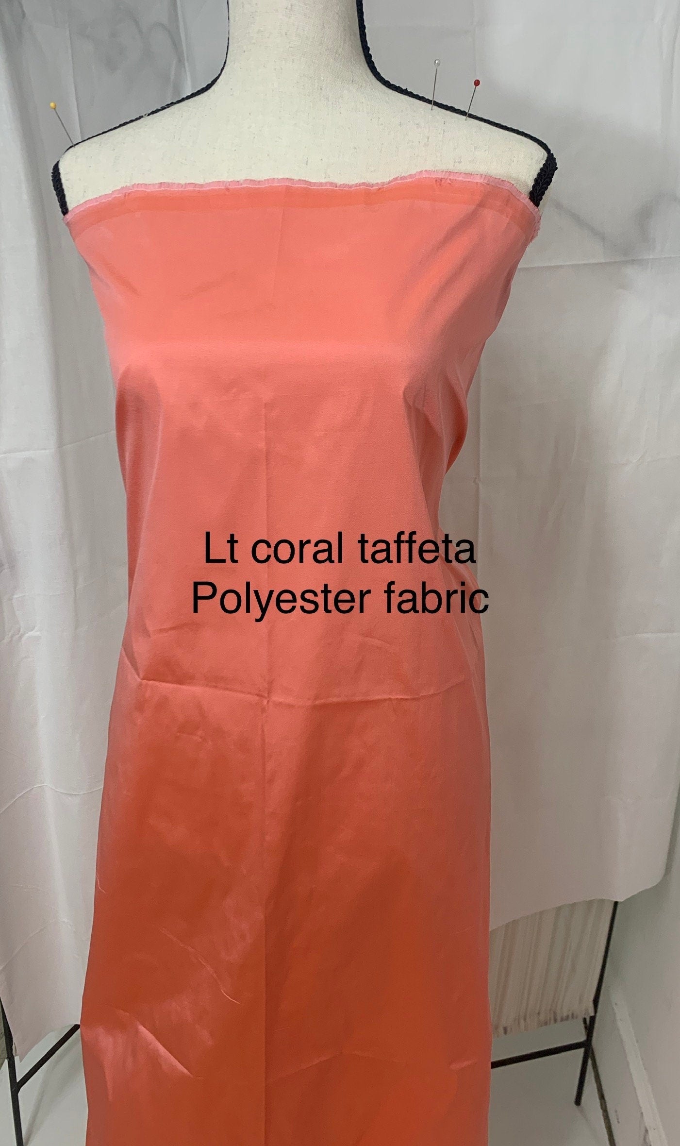 Lt. coral Taffeta fabric . Two tone fabric width 58" polyester, has a slight tone of orange and pink shading. free sample. item 113