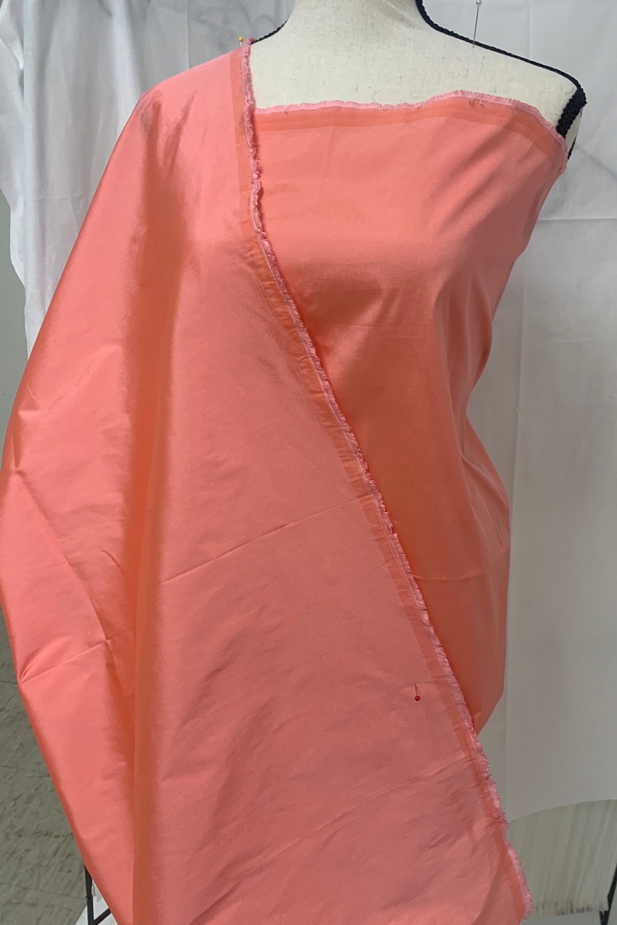 Lt. coral Taffeta fabric . Two tone fabric width 58" polyester, has a slight tone of orange and pink shading. free sample. item 113