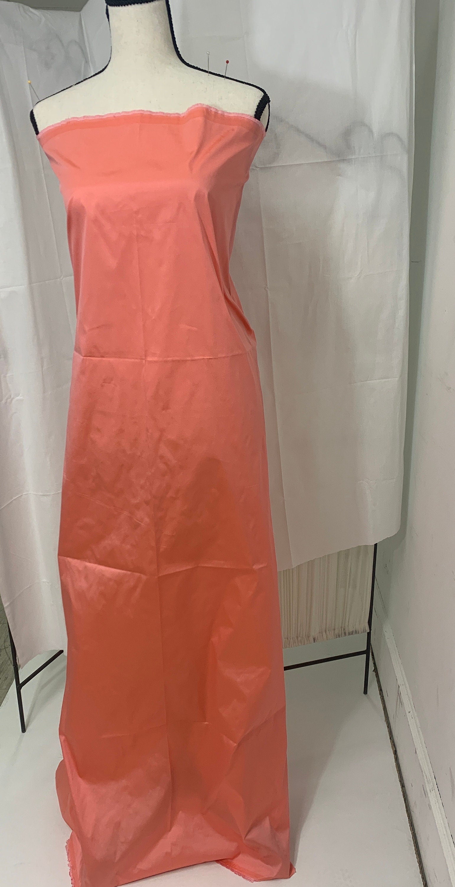 Lt. coral Taffeta fabric . Two tone fabric width 58" polyester, has a slight tone of orange and pink shading. free sample. item 113