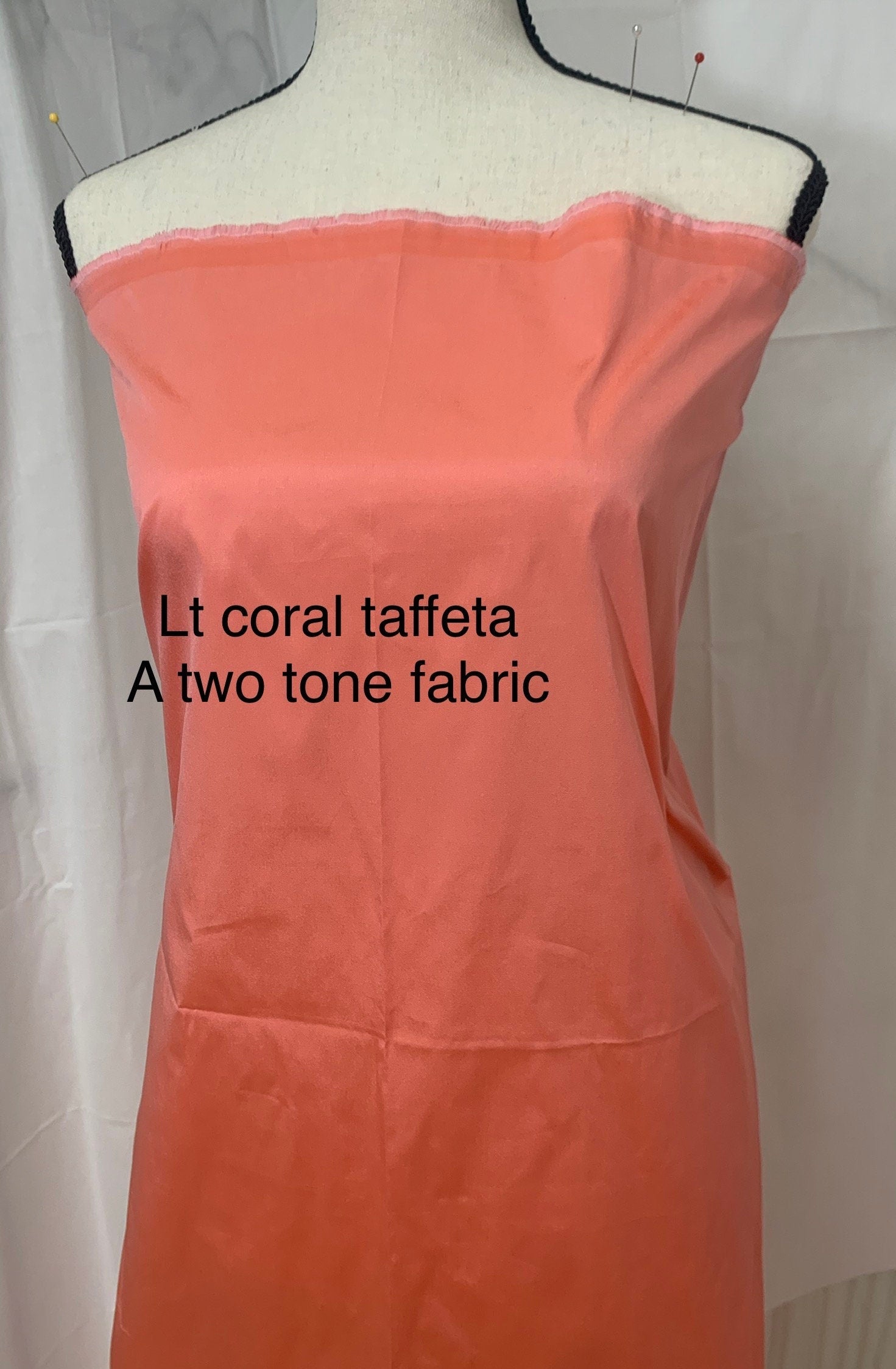 Lt. coral Taffeta fabric . Two tone fabric width 58" polyester, has a slight tone of orange and pink shading. free sample. item 113