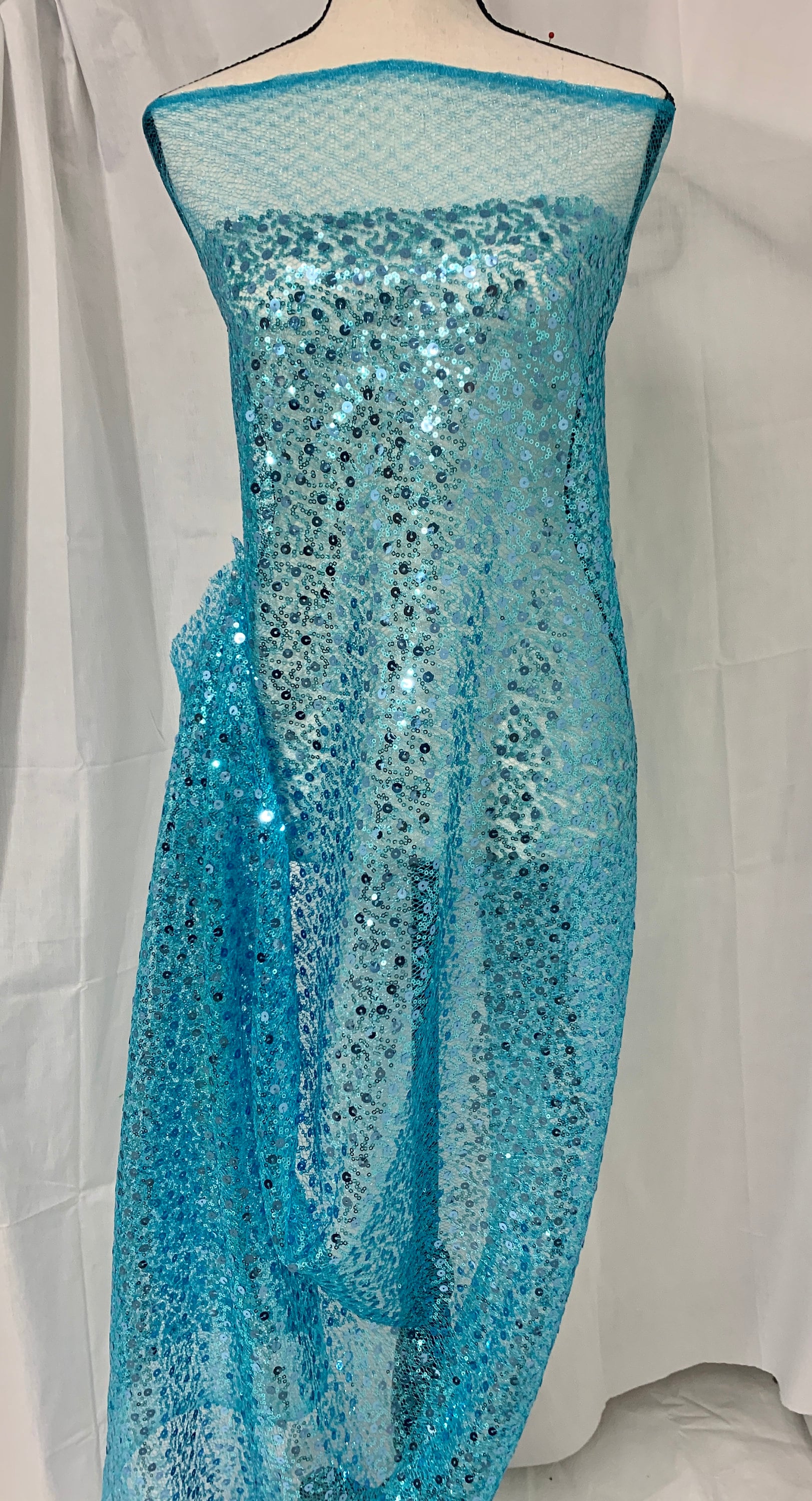 Turquoise Sequence mesh fabric, width 58", sell by yard, 3" plain mesh salvage on each side. great item for dress, costume, decoration.