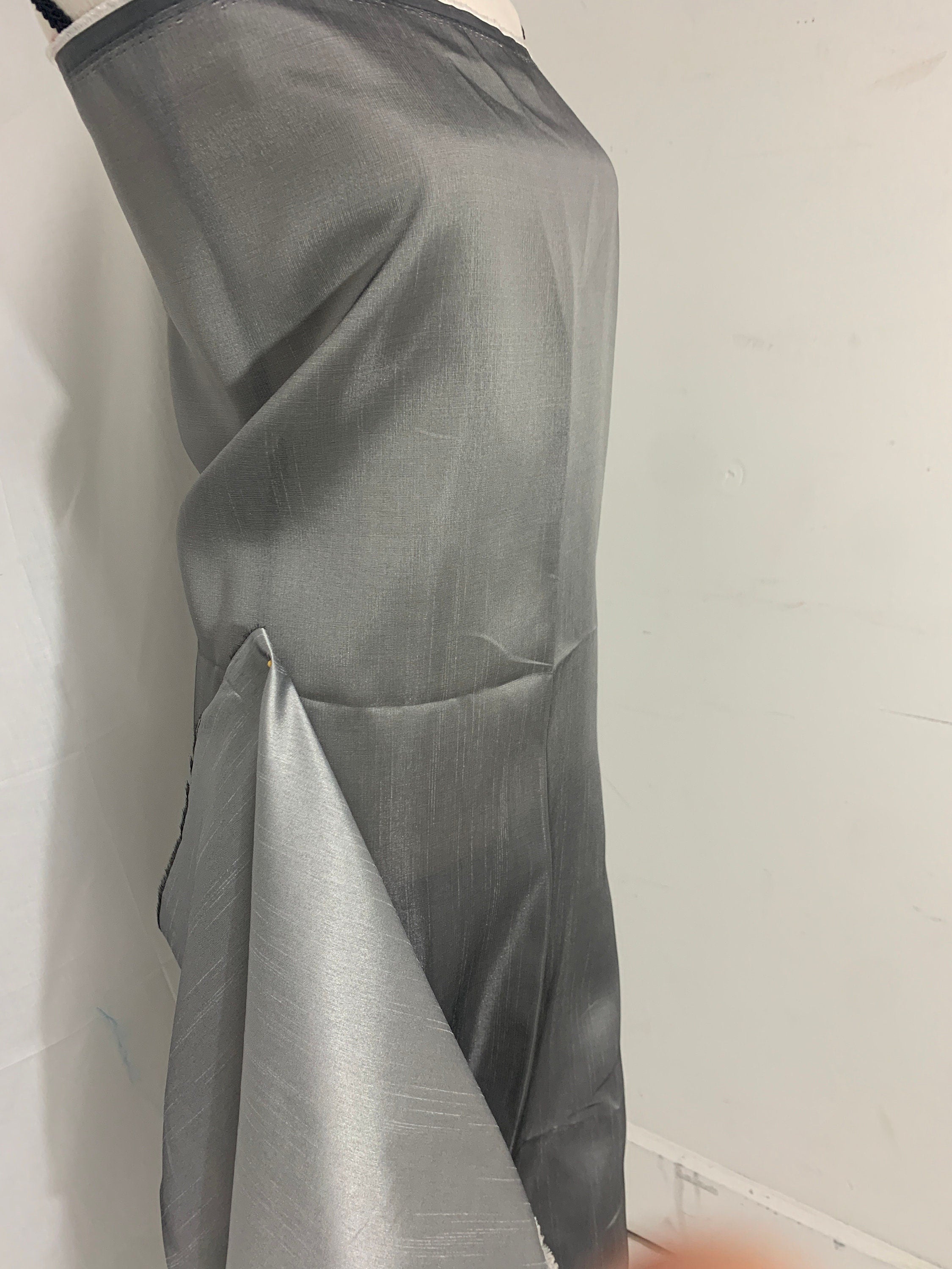 silver grey shimmer shantung fabric, width 58". Is a double sided fabric with slub, shimmery and dull sides dry clean fabric. Free sample.