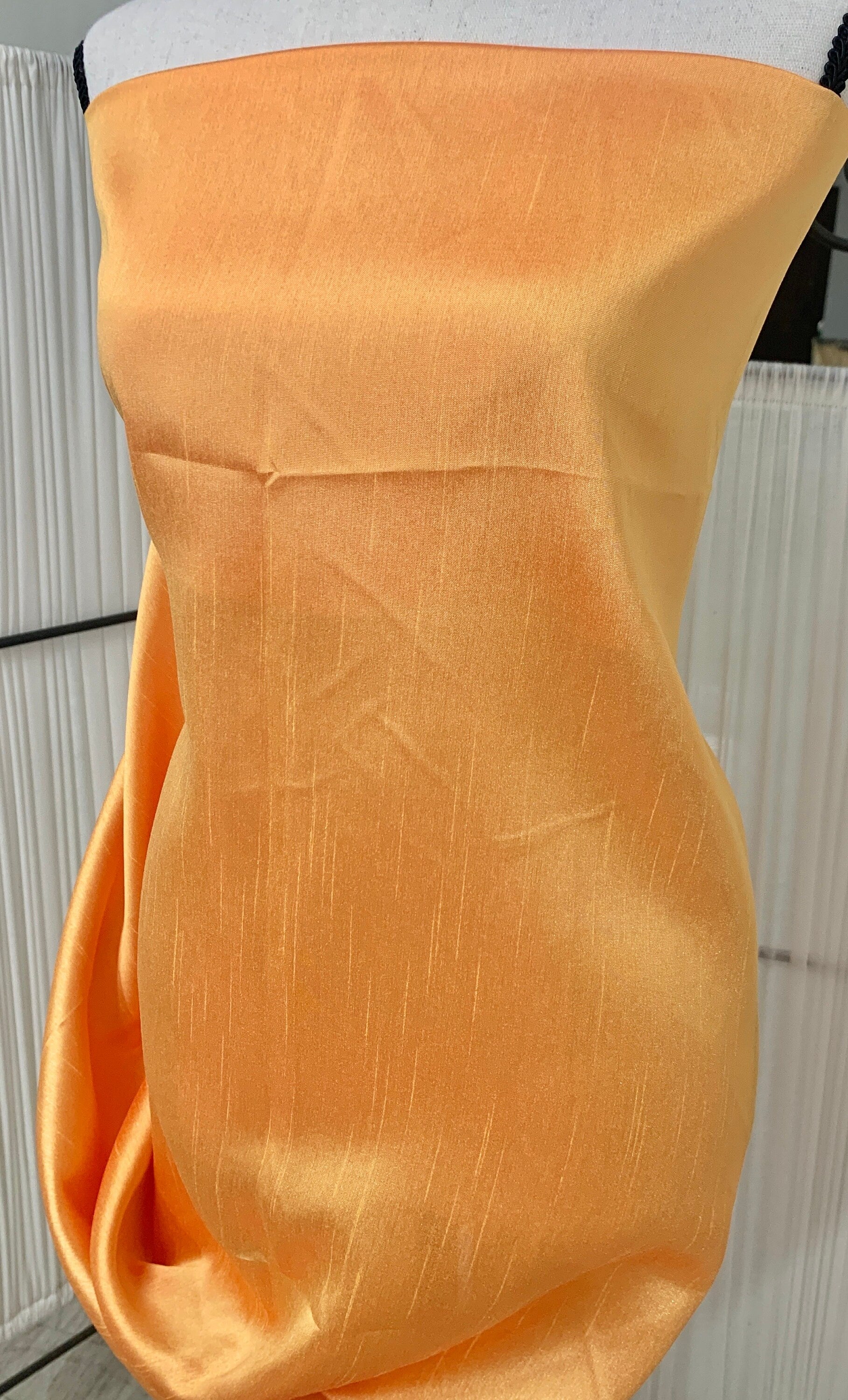 Gold Shimmer fabric two tone threads in yellow and orange, creating an orange sheen. Requires dry cleaning for maintenance. Free sample.