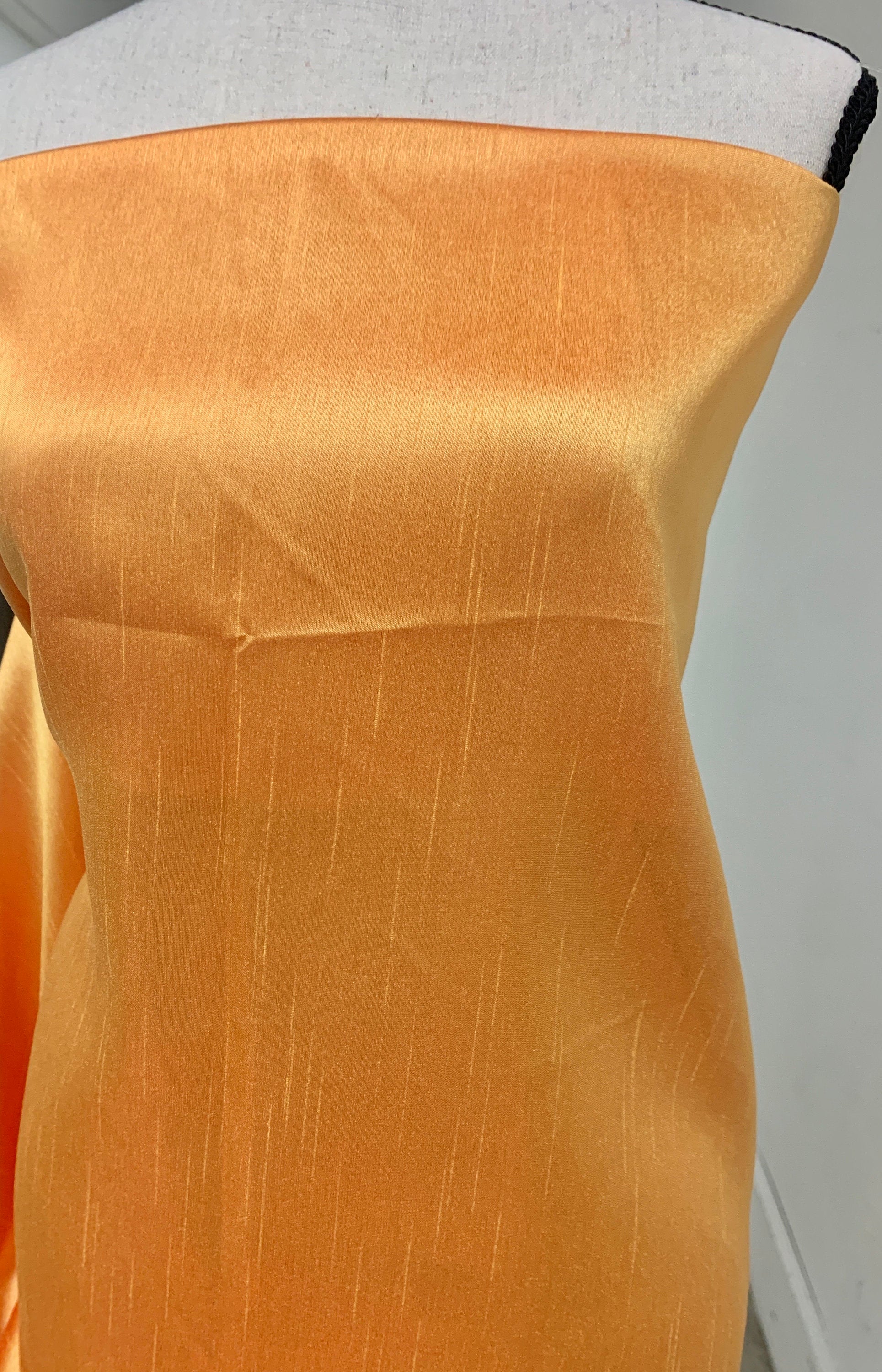Gold Shimmer fabric two tone threads in yellow and orange, creating an orange sheen. Requires dry cleaning for maintenance. Free sample.