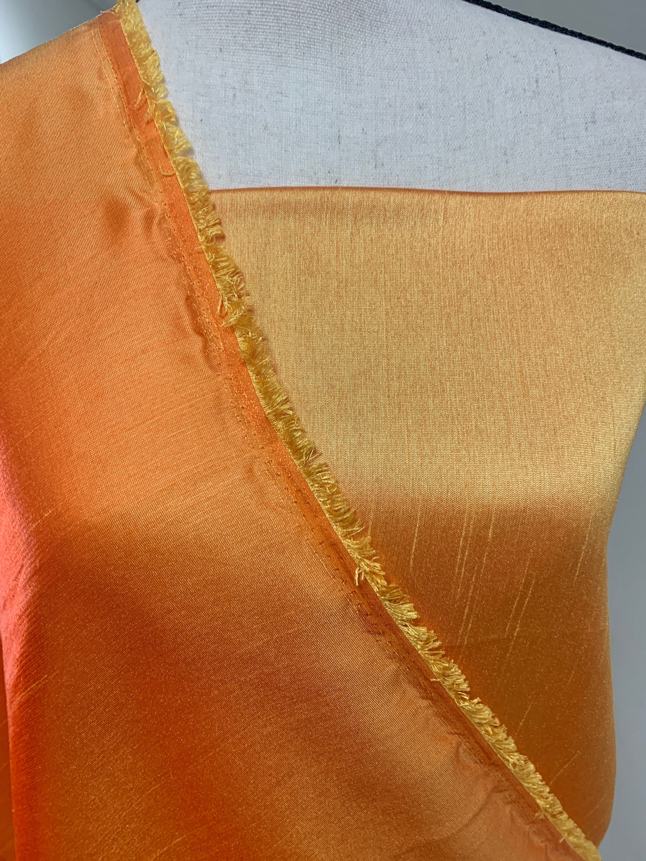 Gold Shimmer fabric two tone threads in yellow and orange, creating an orange sheen. Requires dry cleaning for maintenance. Free sample.