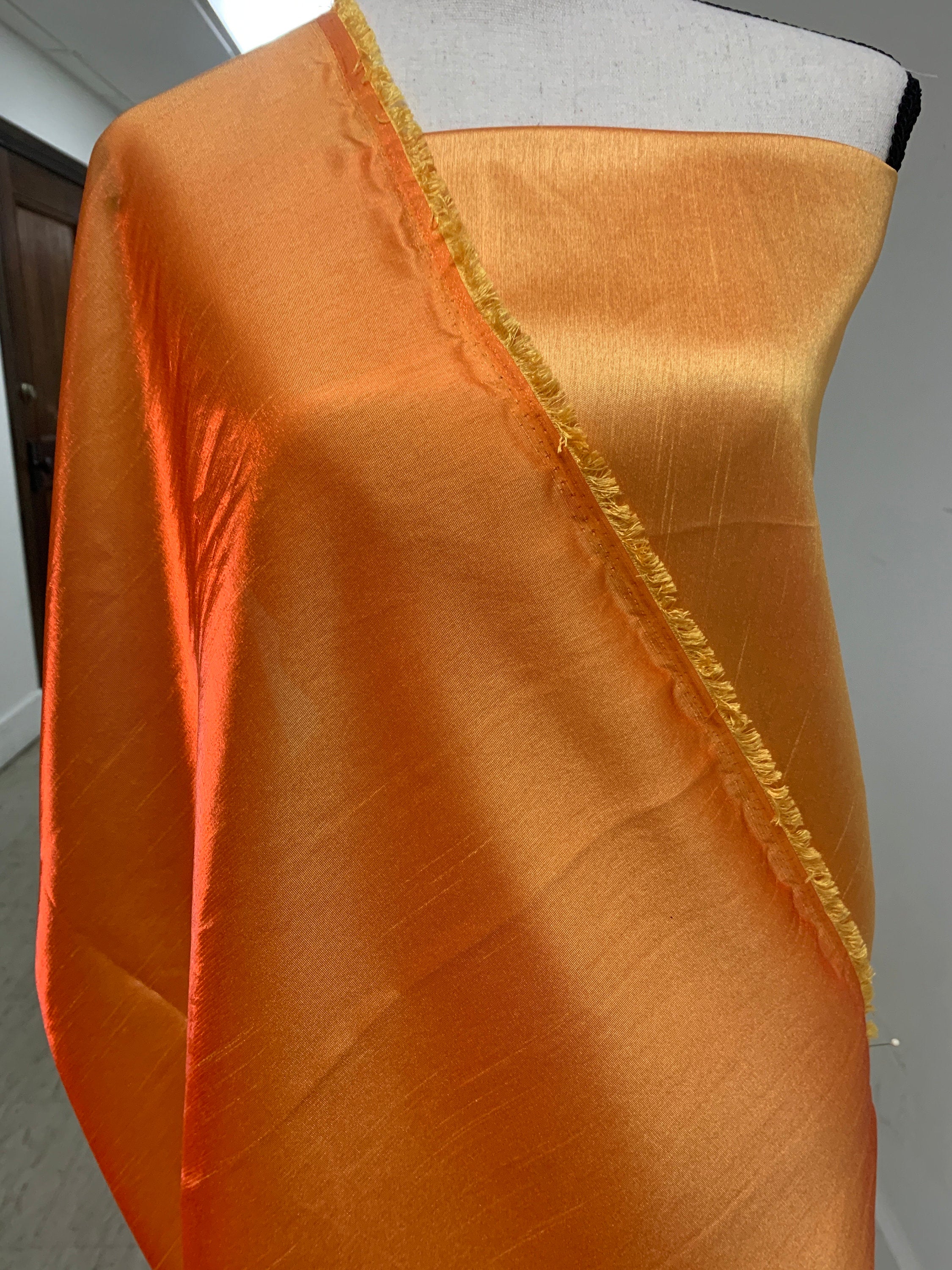 Gold Shimmer fabric two tone threads in yellow and orange, creating an orange sheen. Requires dry cleaning for maintenance. Free sample.