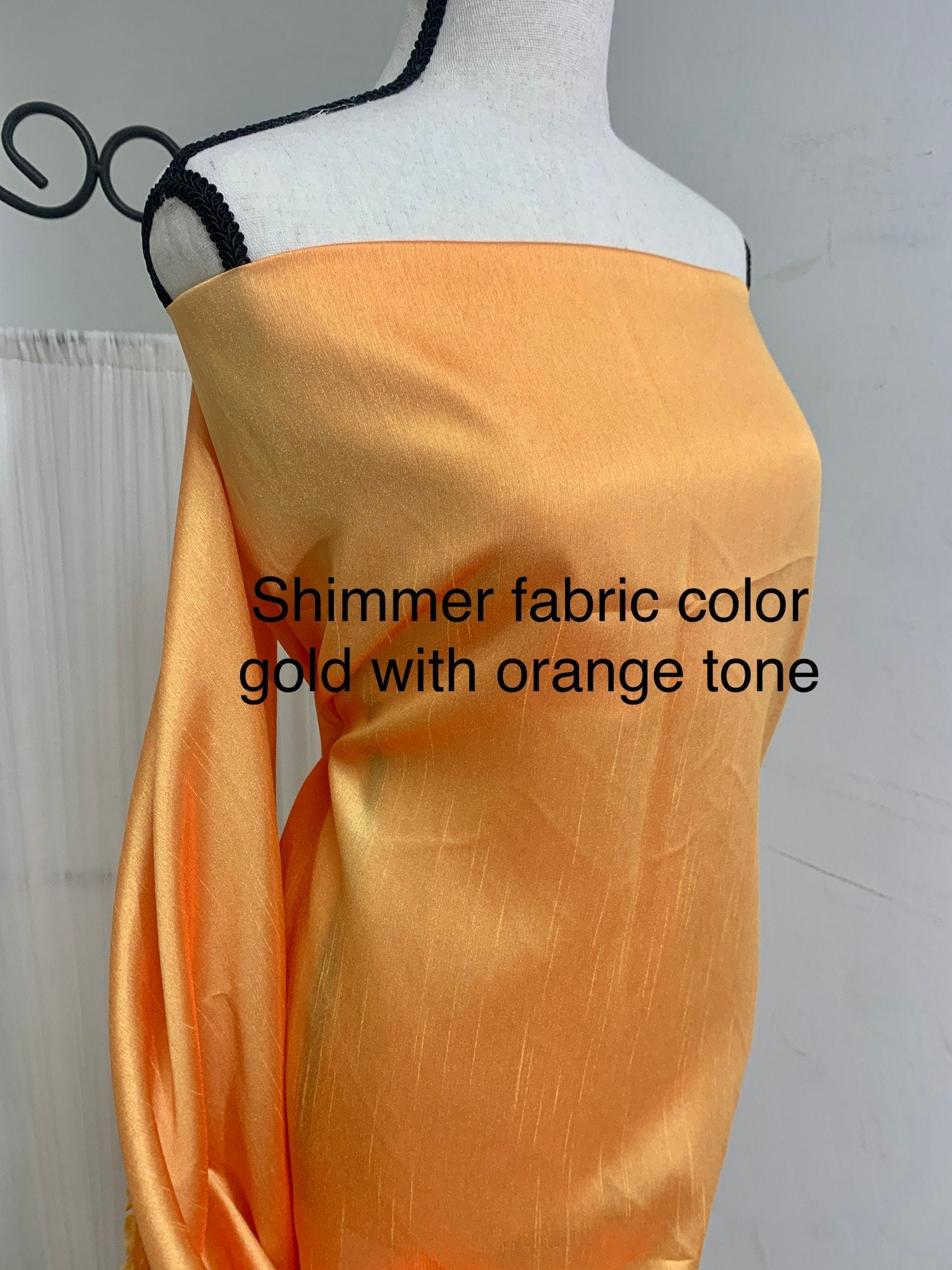 Gold Shimmer fabric two tone threads in yellow and orange, creating an orange sheen. Requires dry cleaning for maintenance. Free sample.
