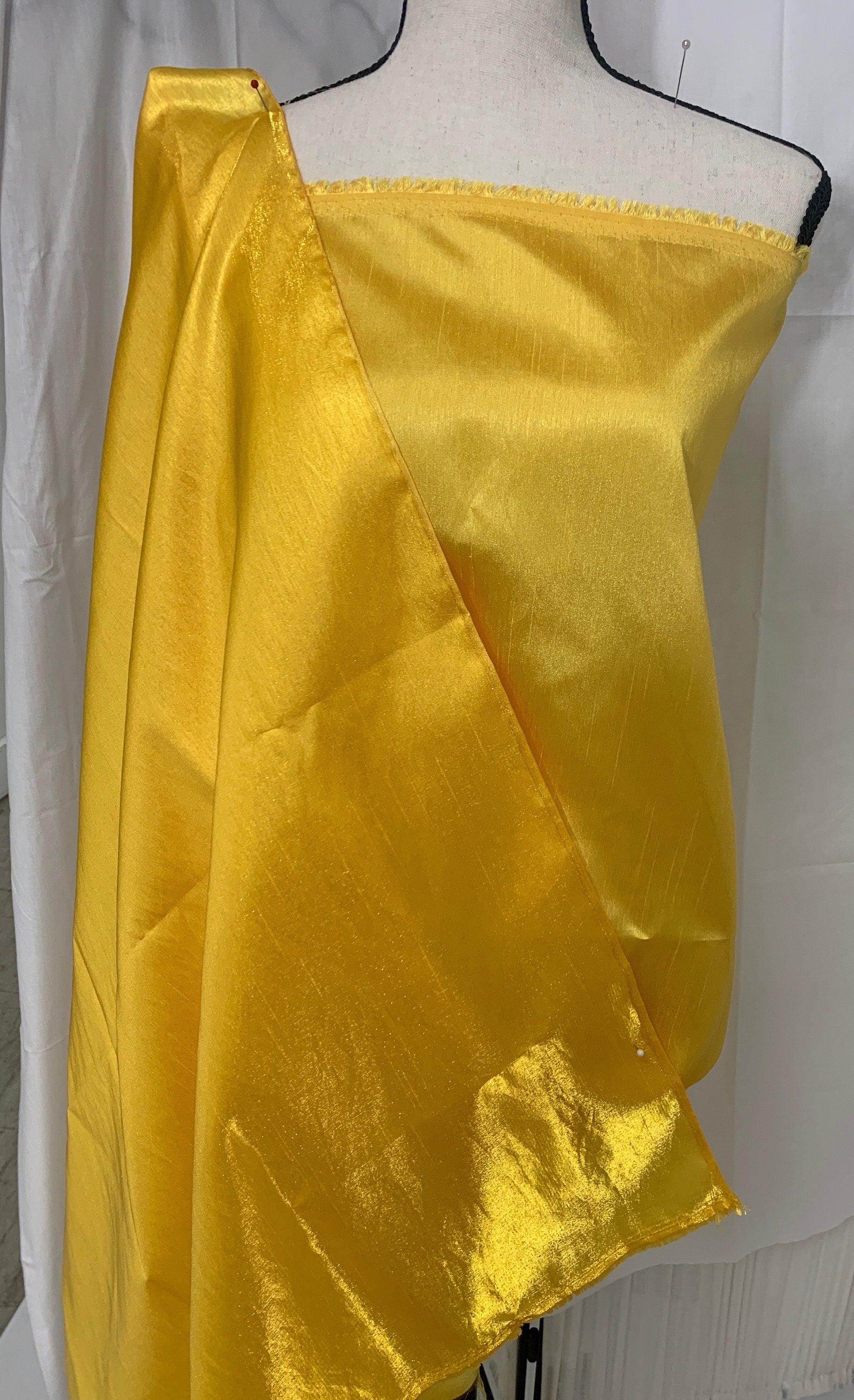 Yellow shimmer shantung fabric, width 58". Is a double sided fabric with slub, shimmery and dull sides dry clean fabric. Free sample.