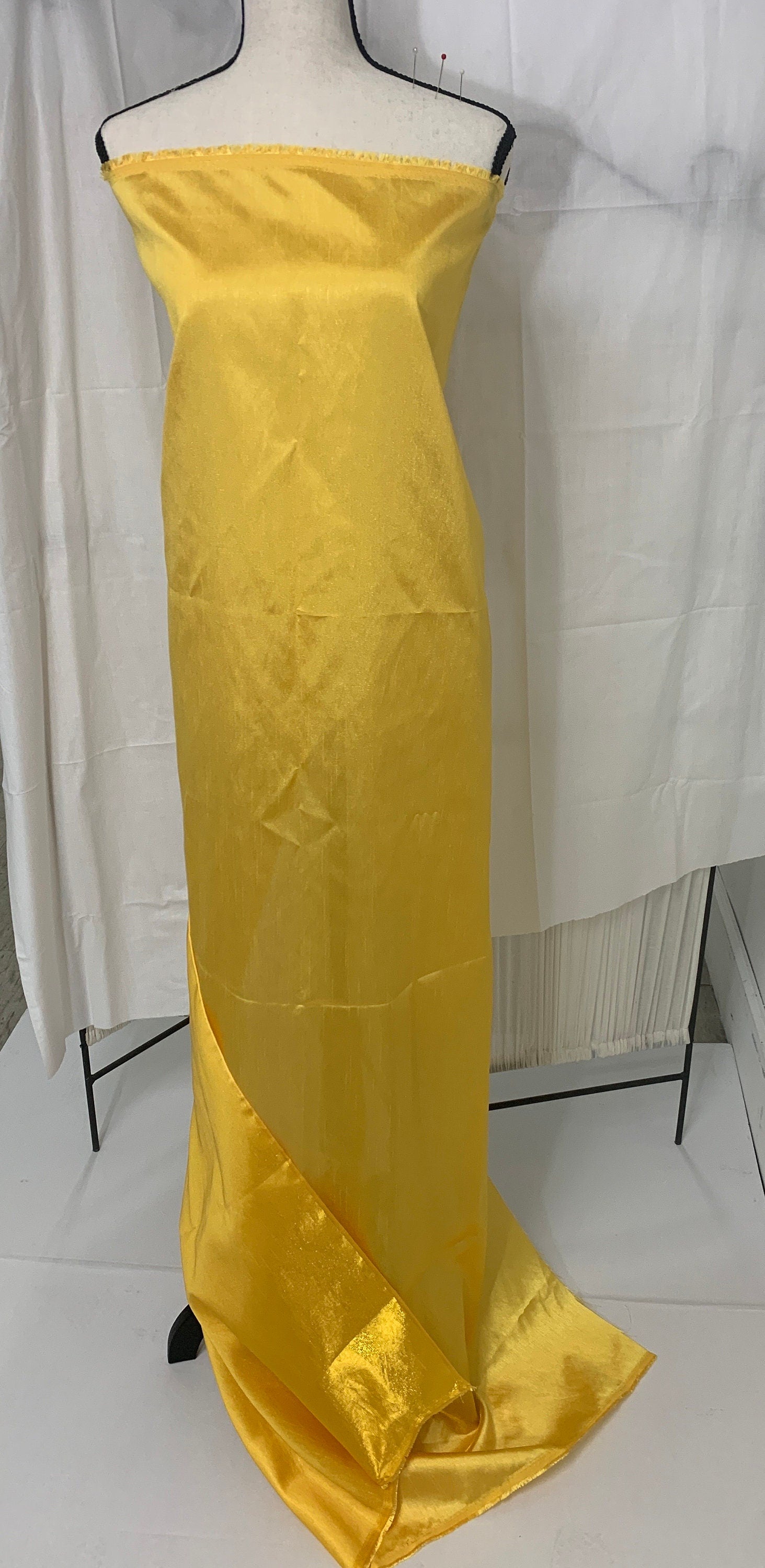 Yellow shimmer shantung fabric, width 58". Is a double sided fabric with slub, shimmery and dull sides dry clean fabric. Free sample.