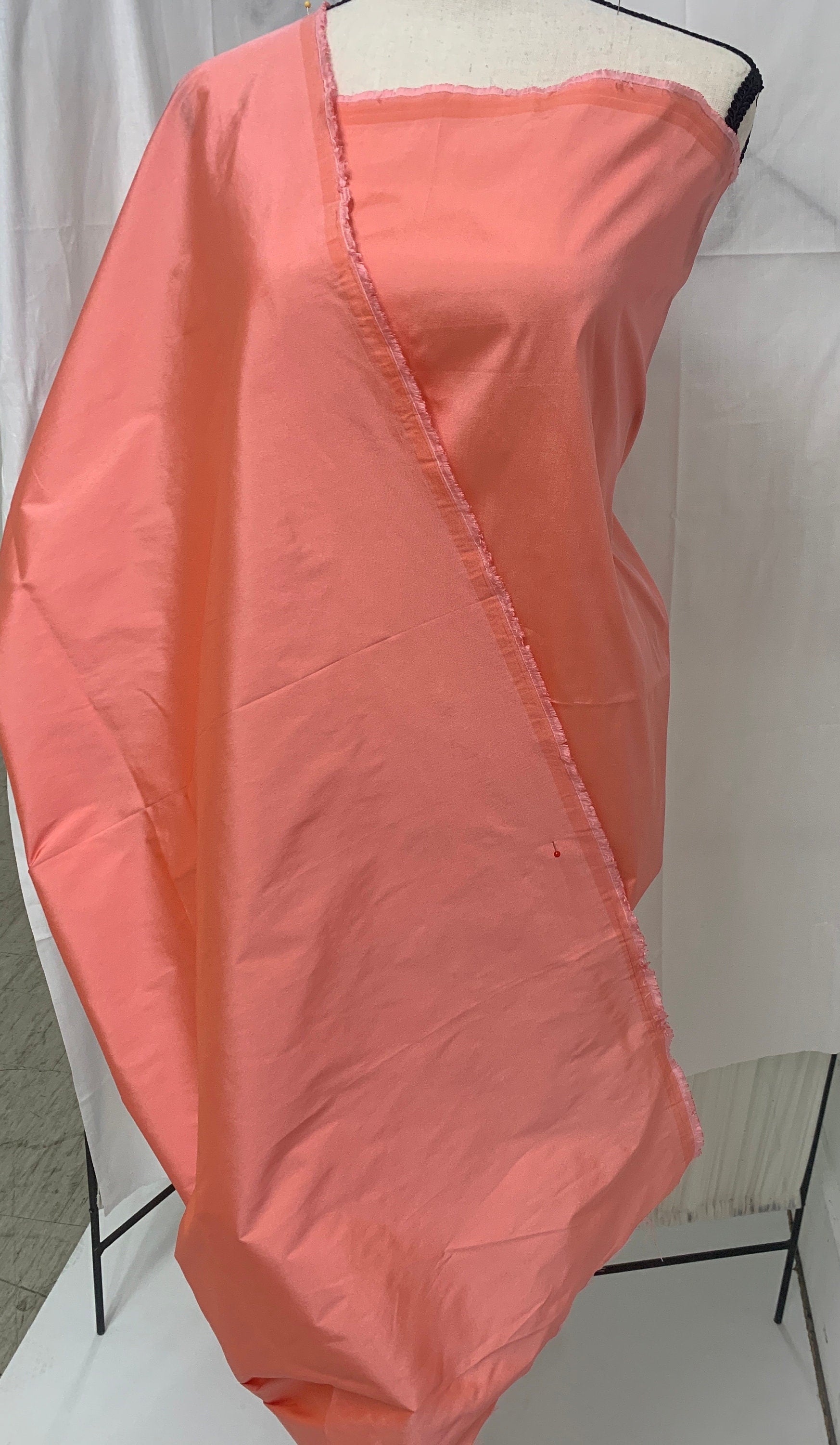 Lt. coral Taffeta fabric . Two tone fabric width 58" polyester, has a slight tone of orange and pink shading. free sample. item 113