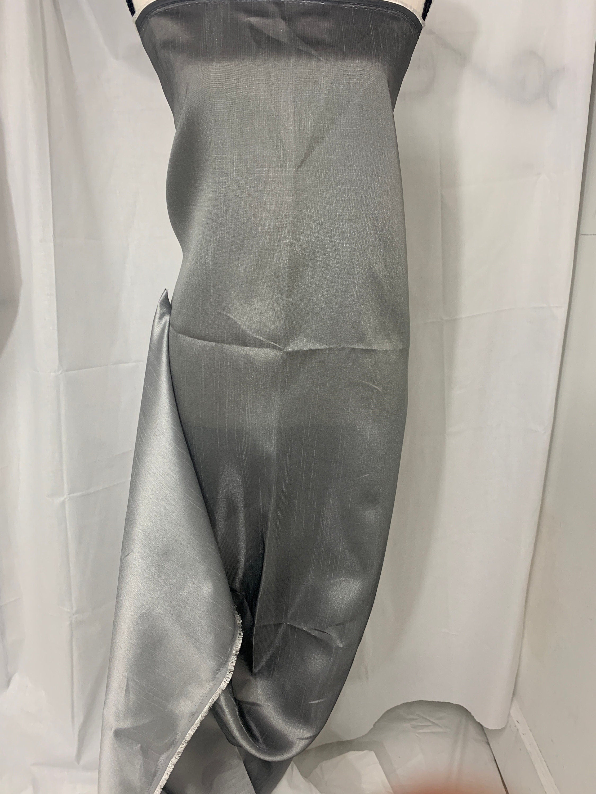 silver grey shimmer shantung fabric, width 58". Is a double sided fabric with slub, shimmery and dull sides dry clean fabric. Free sample.