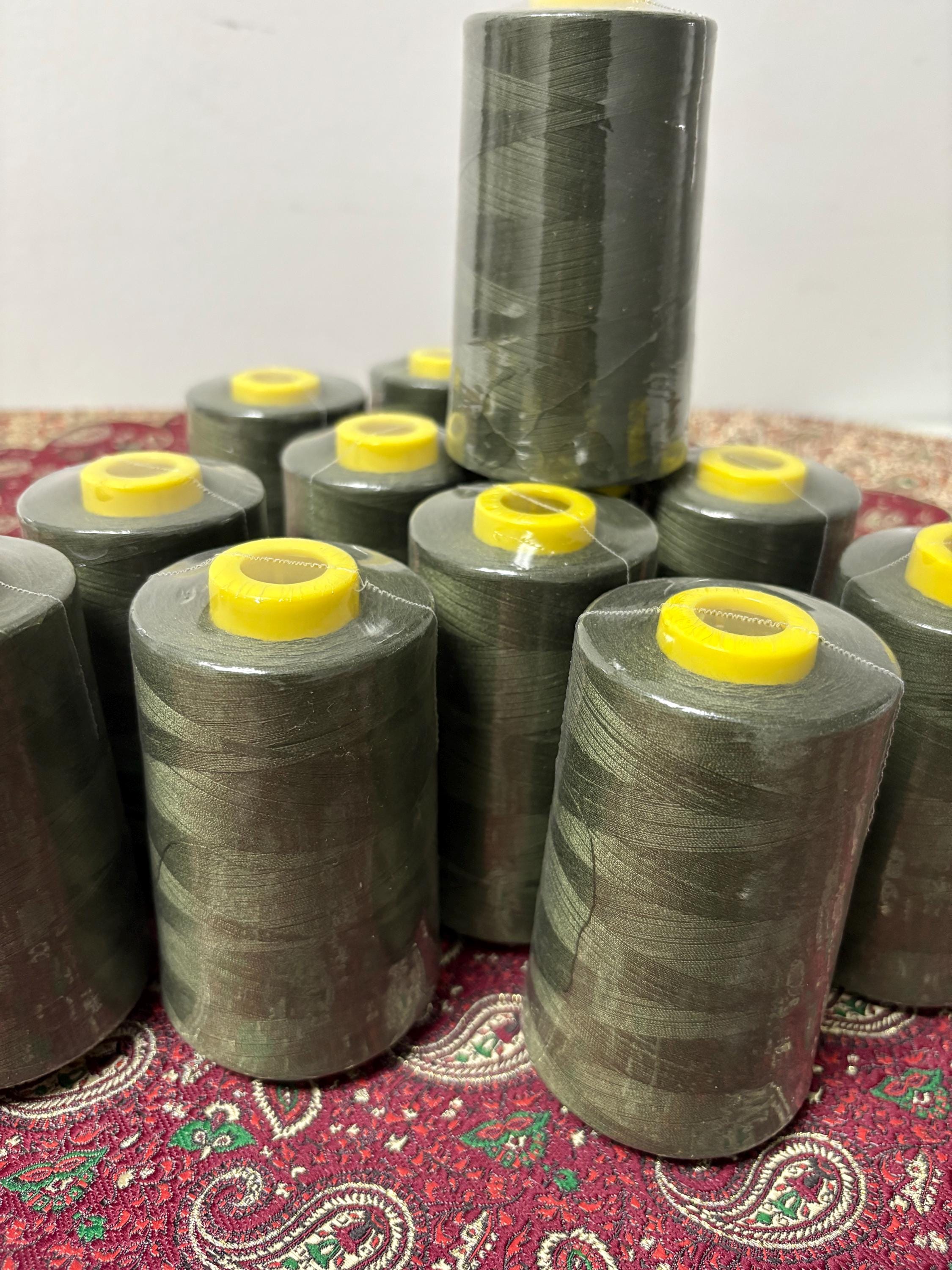 Olive sewing threads, polyester 130 gram per cone, 5000 yards per cone, wrap in clear cover for daily sewing. size 24T. made in usa. PT 945