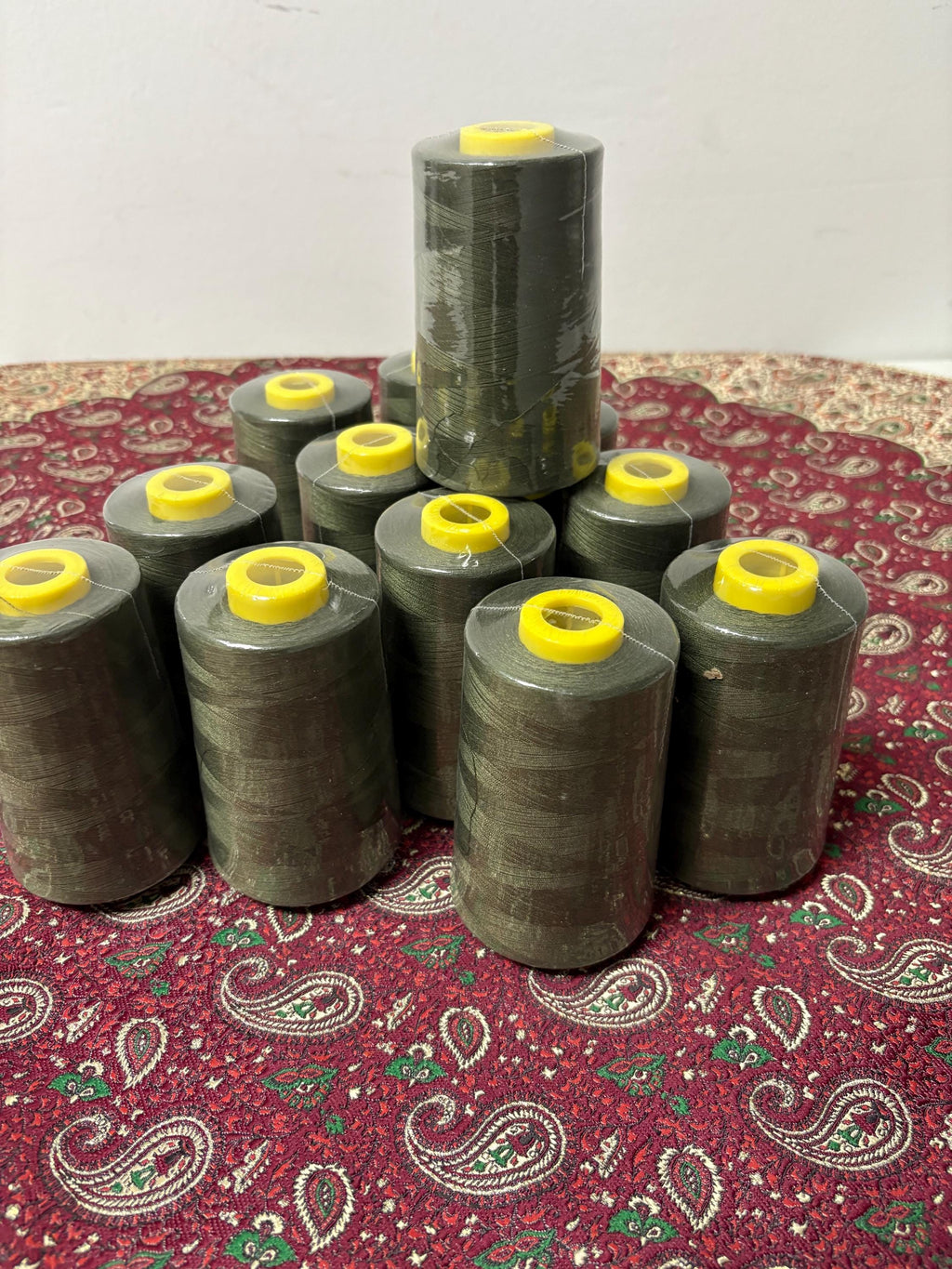 Olive sewing threads, polyester 130 gram per cone, 5000 yards per cone, wrap in clear cover for daily sewing. size 24T. made in usa. PT 945