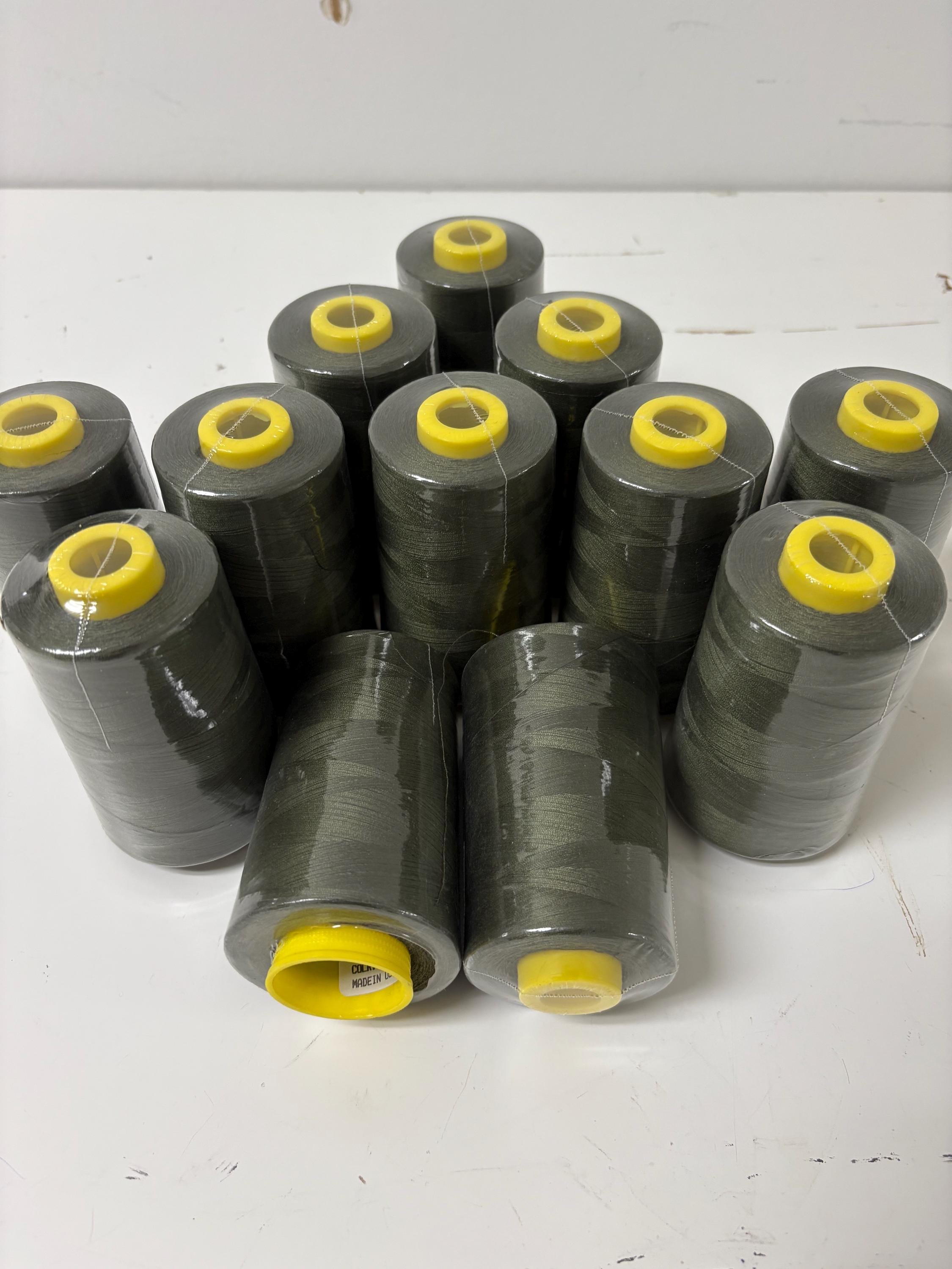 Olive sewing threads, polyester 130 gram per cone, 5000 yards per cone, wrap in clear cover for daily sewing. size 24T. made in usa. PT 945