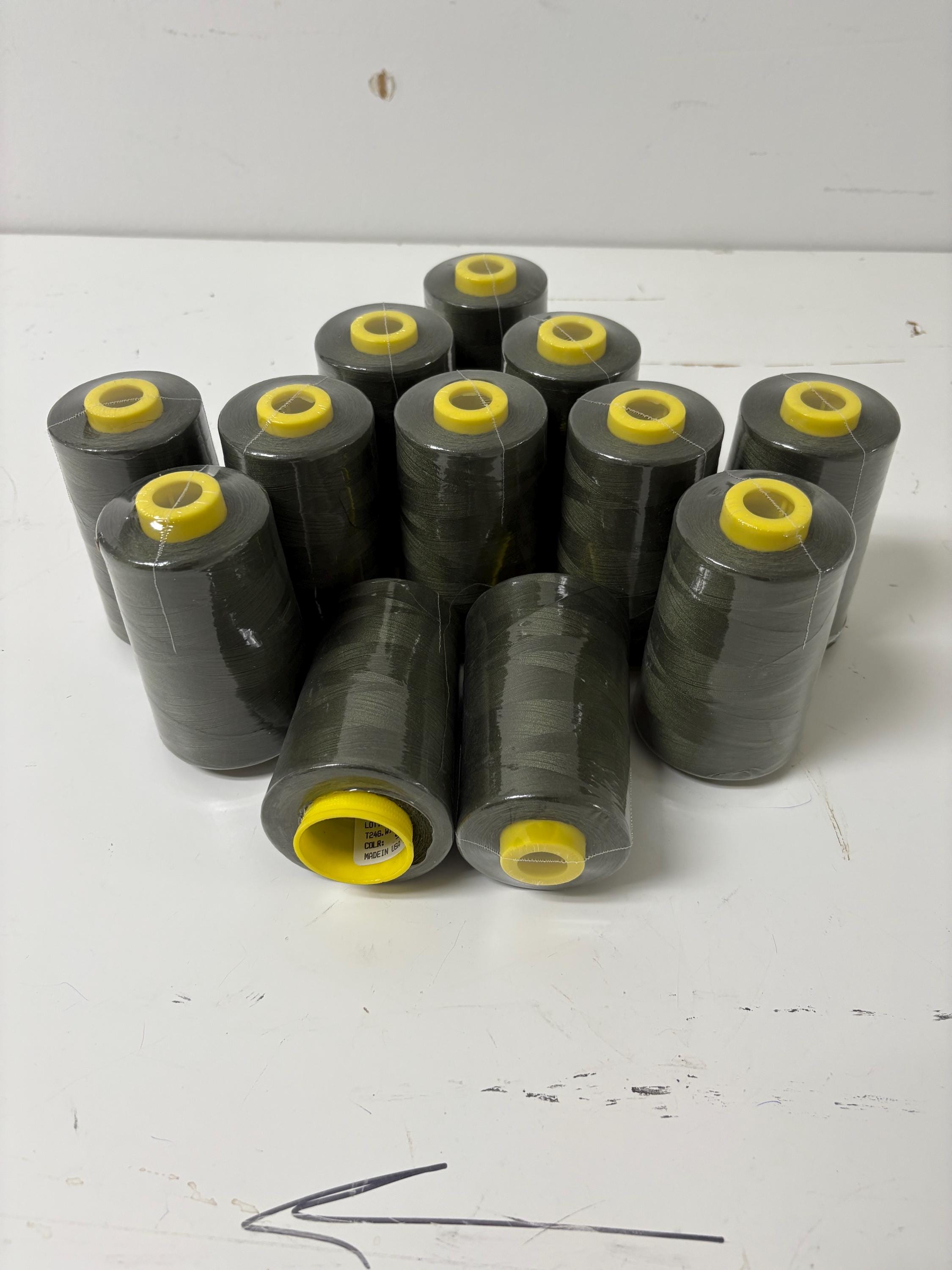 Olive sewing threads, polyester 130 gram per cone, 5000 yards per cone, wrap in clear cover for daily sewing. size 24T. made in usa. PT 945