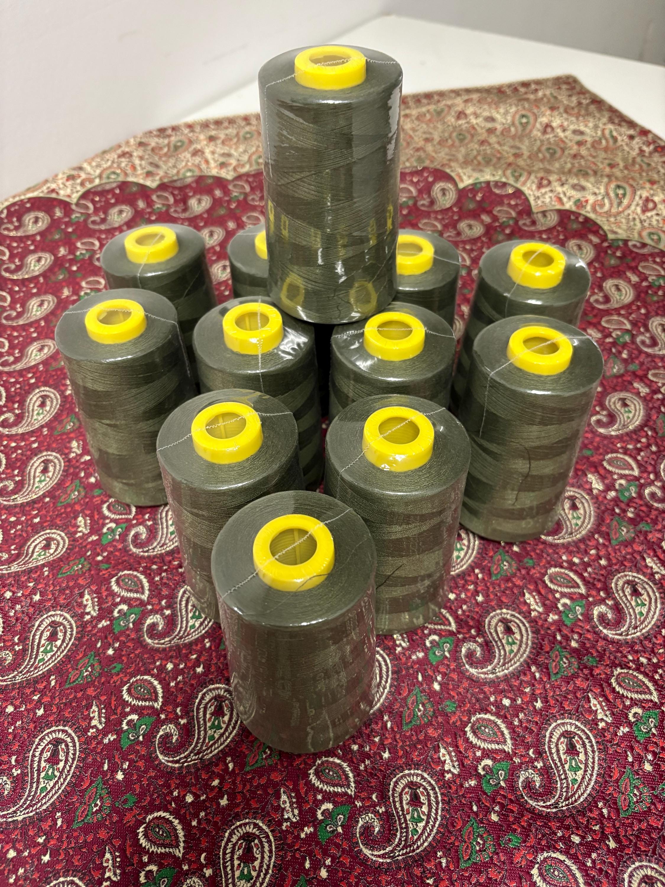 Olive sewing threads, polyester 130 gram per cone, 5000 yards per cone, wrap in clear cover for daily sewing. size 24T. made in usa. PT 945