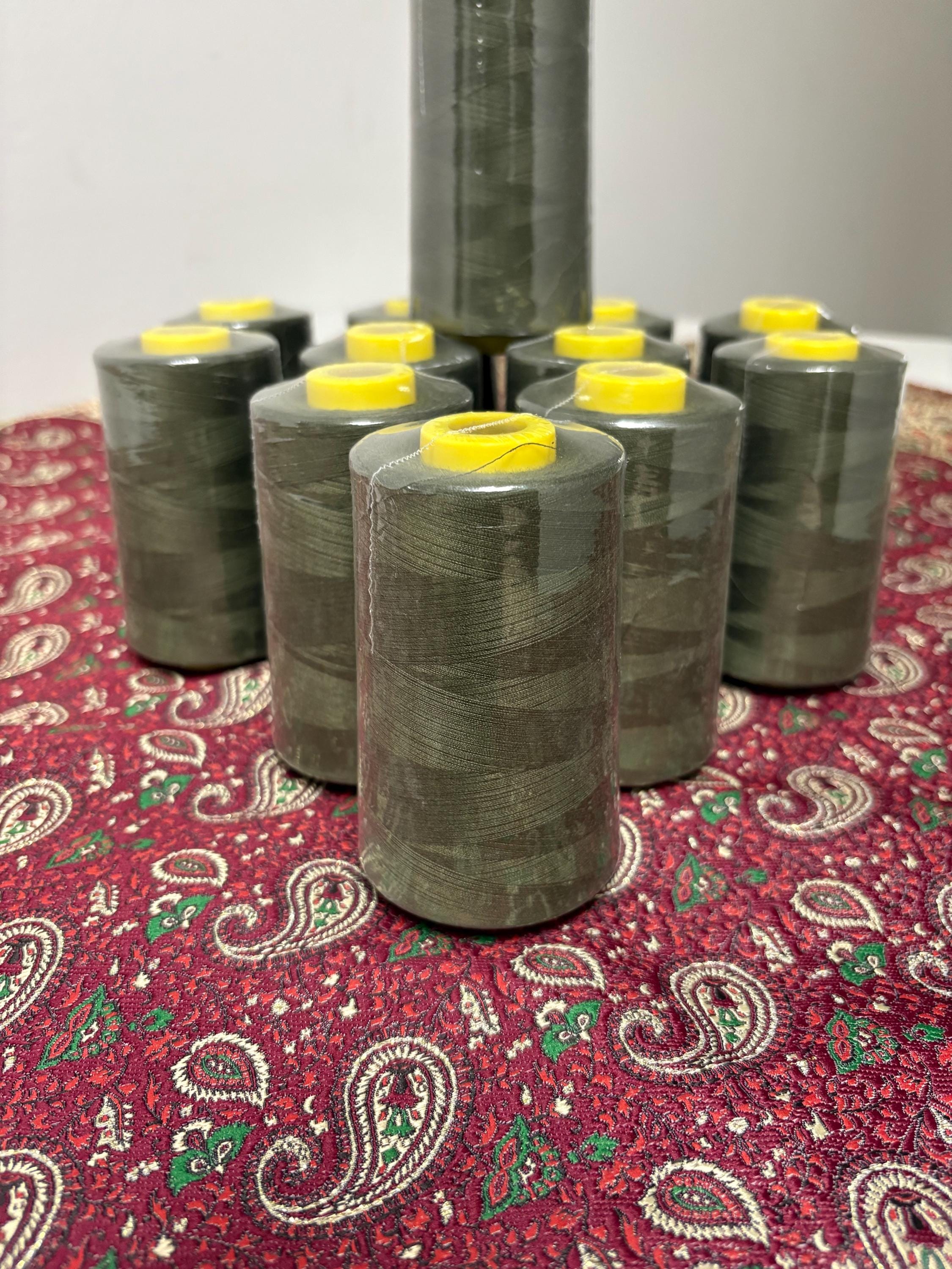 Olive sewing threads, polyester 130 gram per cone, 5000 yards per cone, wrap in clear cover for daily sewing. size 24T. made in usa. PT 945