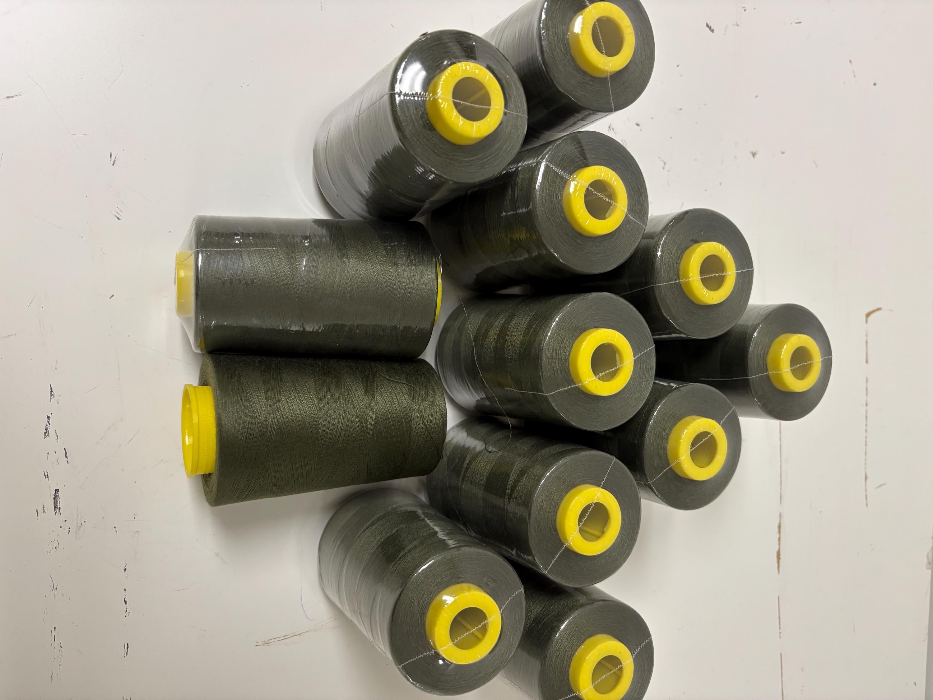 Olive sewing threads, polyester 130 gram per cone, 5000 yards per cone, wrap in clear cover for daily sewing. size 24T. made in usa. PT 945