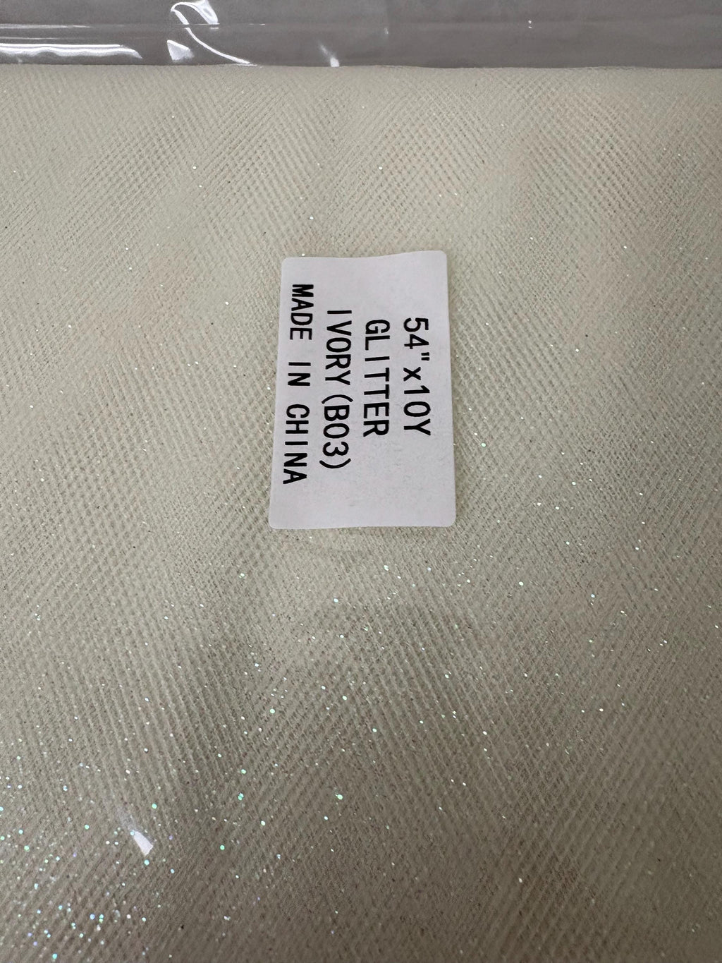Ivory Tulle Gliter 54" double fold, color Ivory with unicorn glitter 10 yards per pack.