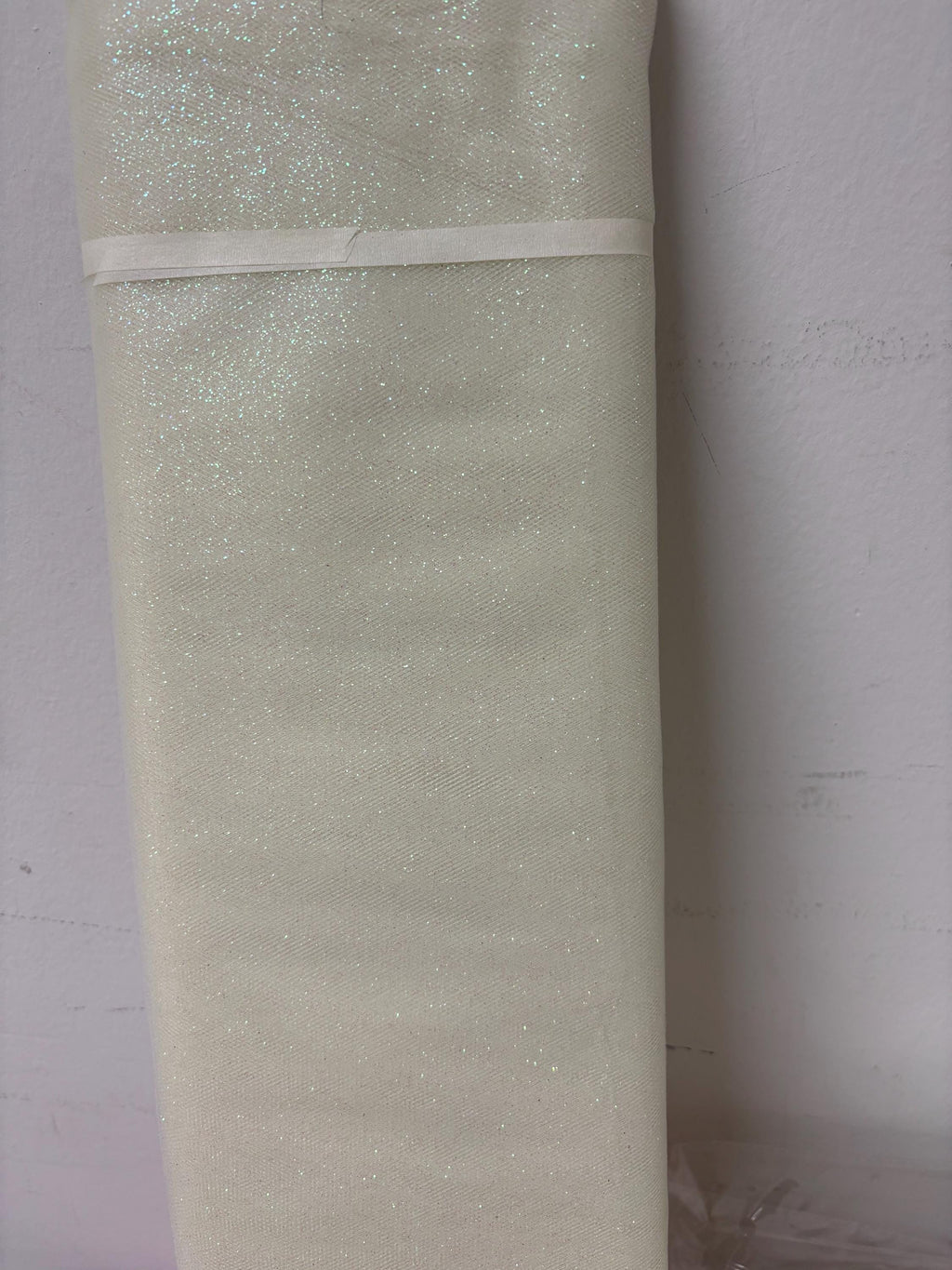 Ivory Tulle Gliter 54" double fold, color Ivory with unicorn glitter 10 yards per pack.