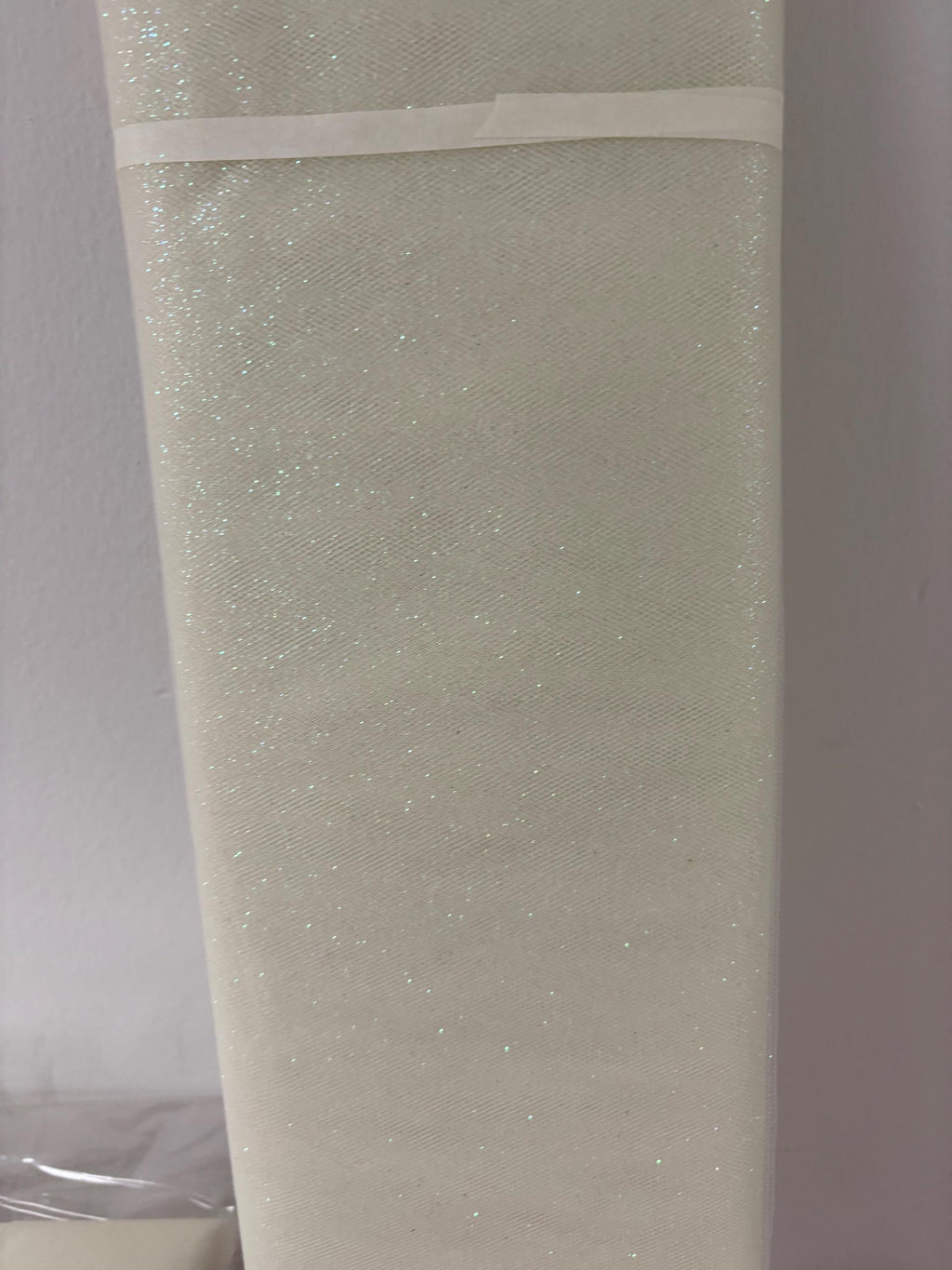 Ivory Tulle Gliter 54" double fold, color Ivory with unicorn glitter 10 yards per pack.