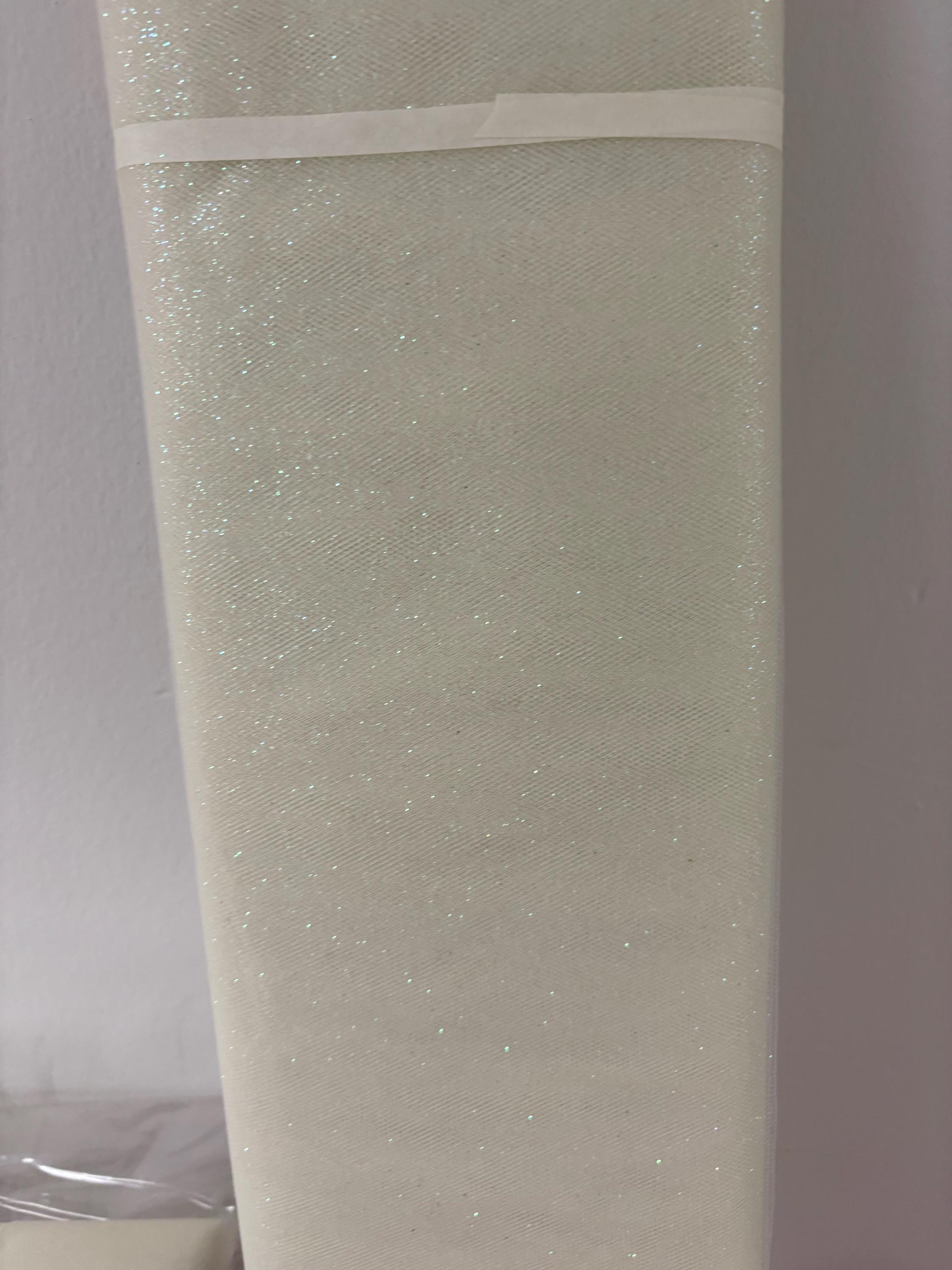 Ivory Tulle Gliter 54" double fold, color Ivory with unicorn glitter 10 yards per pack.