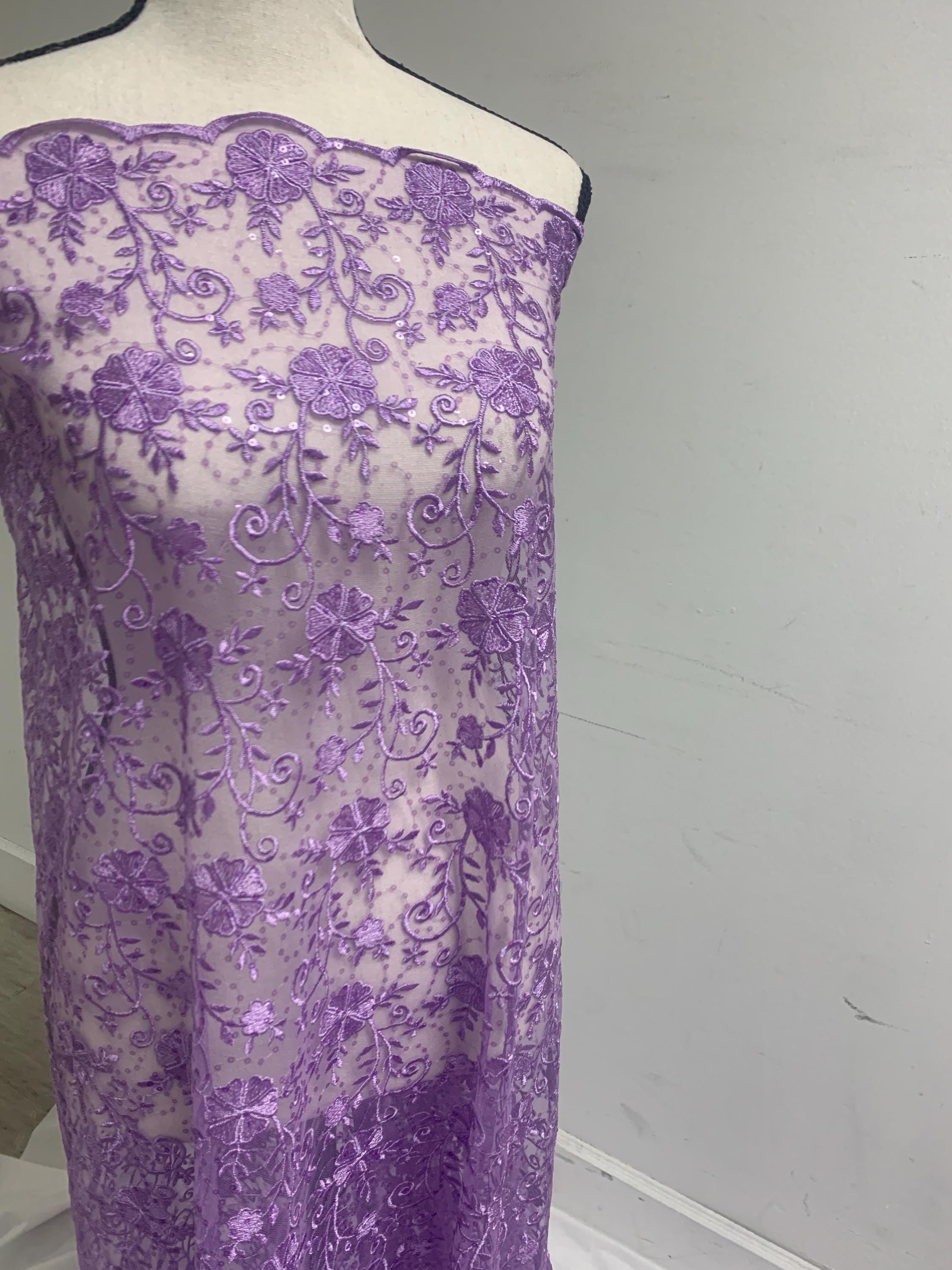 A 3-yard cut of Lilac Lace fabric with a width of 49/50 inches, featuring double scalloped embroidery and sequins. Design code: 04331279.
