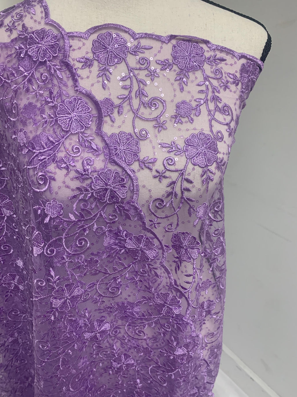 A 3-yard cut of Lilac Lace fabric with a width of 49/50 inches, featuring double scalloped embroidery and sequins. Design code: 04331279.