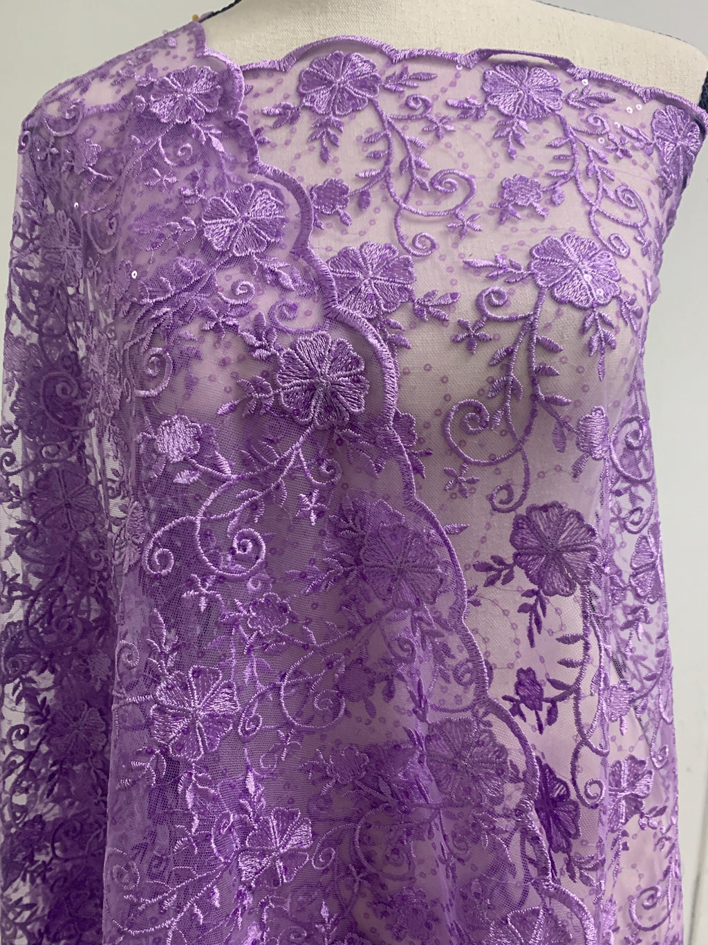 A 3-yard cut of Lilac Lace fabric with a width of 49/50 inches, featuring double scalloped embroidery and sequins. Design code: 04331279.
