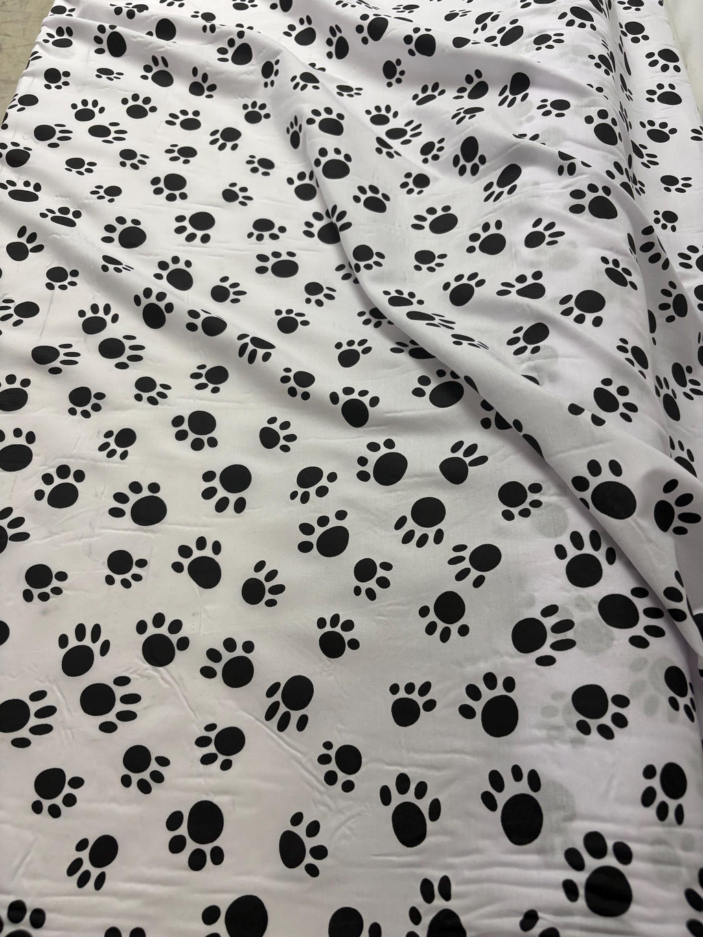 A 2 yard cut Paws print fabric, width 58/60" polyester fabric in black/W, shirt weight. kids crafts. sold by 2 yards and cut continuous.