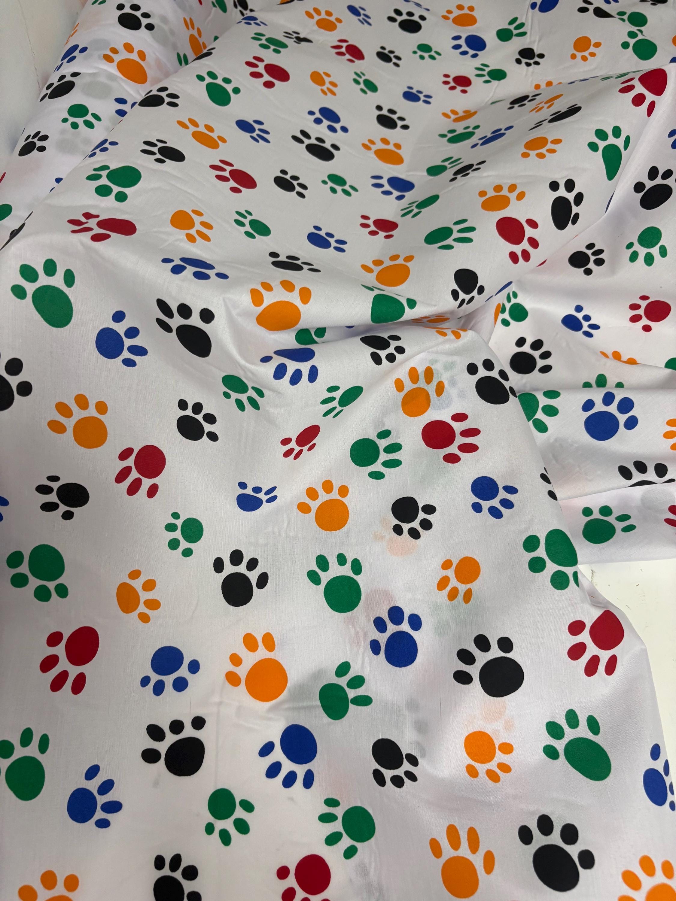 A 2 yard cut Paws print fabric, width 58/60" polyester fabric in Multi color, shirt weight. kids crafts. sold by 2 yards and cut continuous.